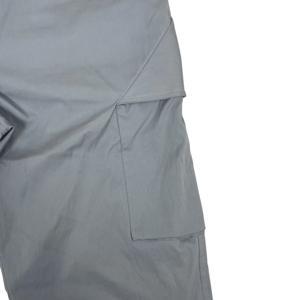 Zenno Archive AFFXWRKS grey nylon cargo pants featuring a sleek side pocket detail on a textured background.