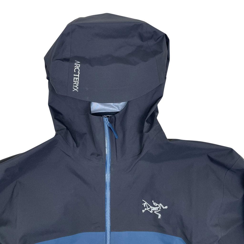 Zenno Archive Arc’teryx Beta Gore-Tex jacket in black and blue with a hooded design and white logo embroidery.