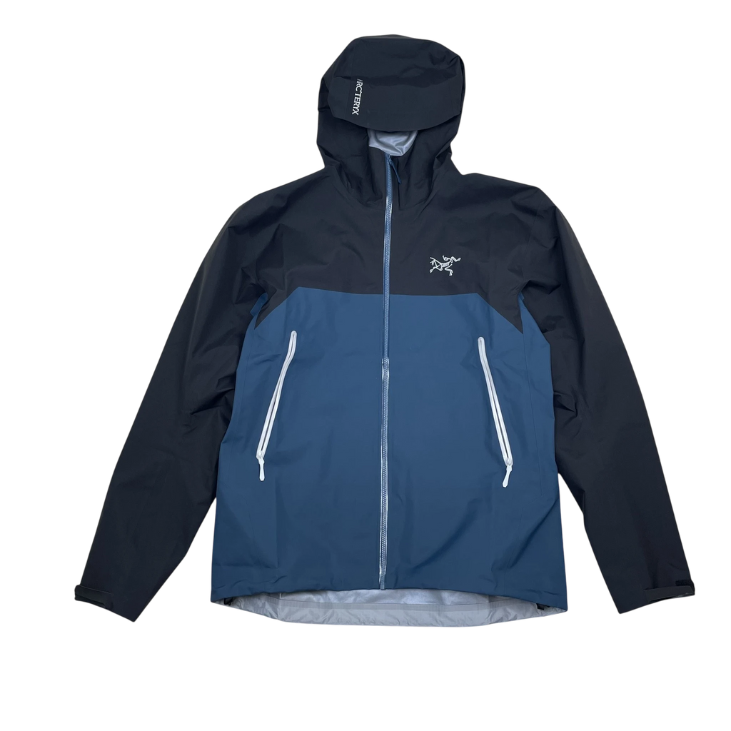 Zenno Archive Arc’teryx Beta Gore-Tex jacket in black and blue with a hooded design and front zip pockets.