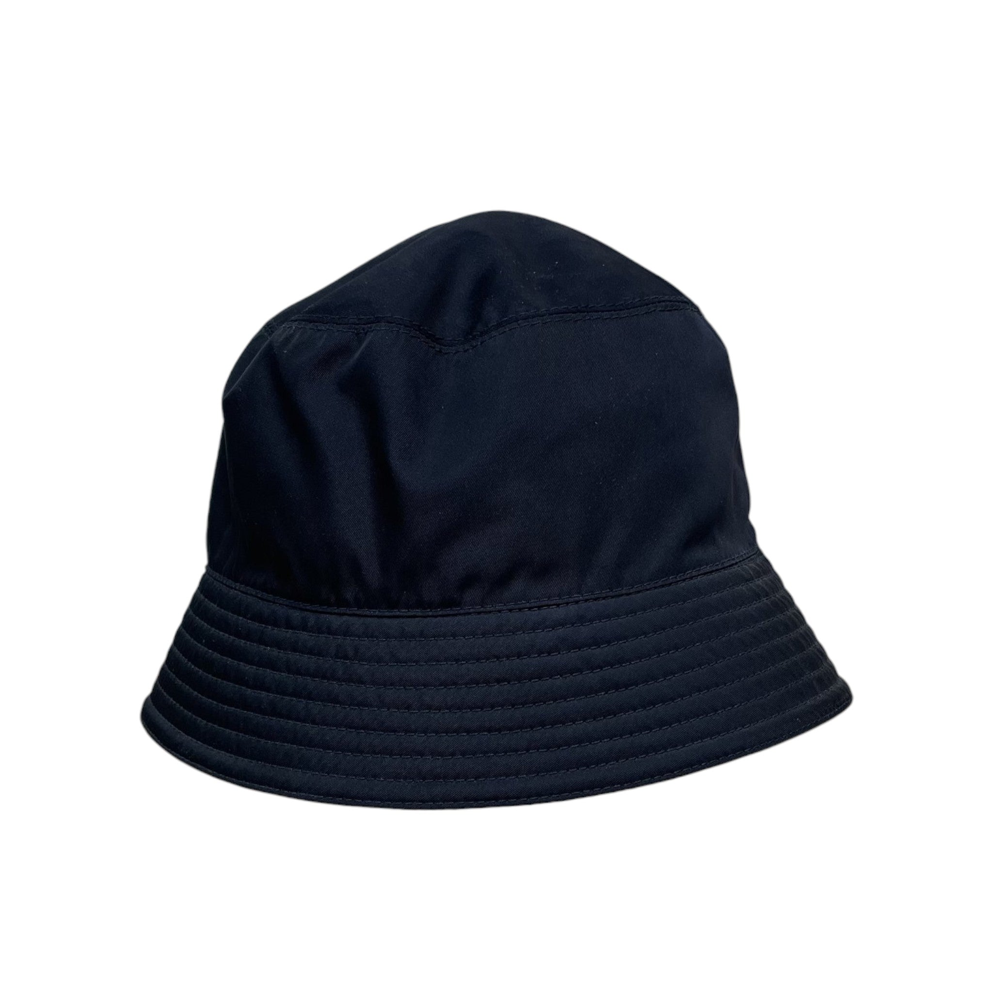 Zenno Archive black nylon bucket hat with iconic triangle logo plaque on a metal display stand
