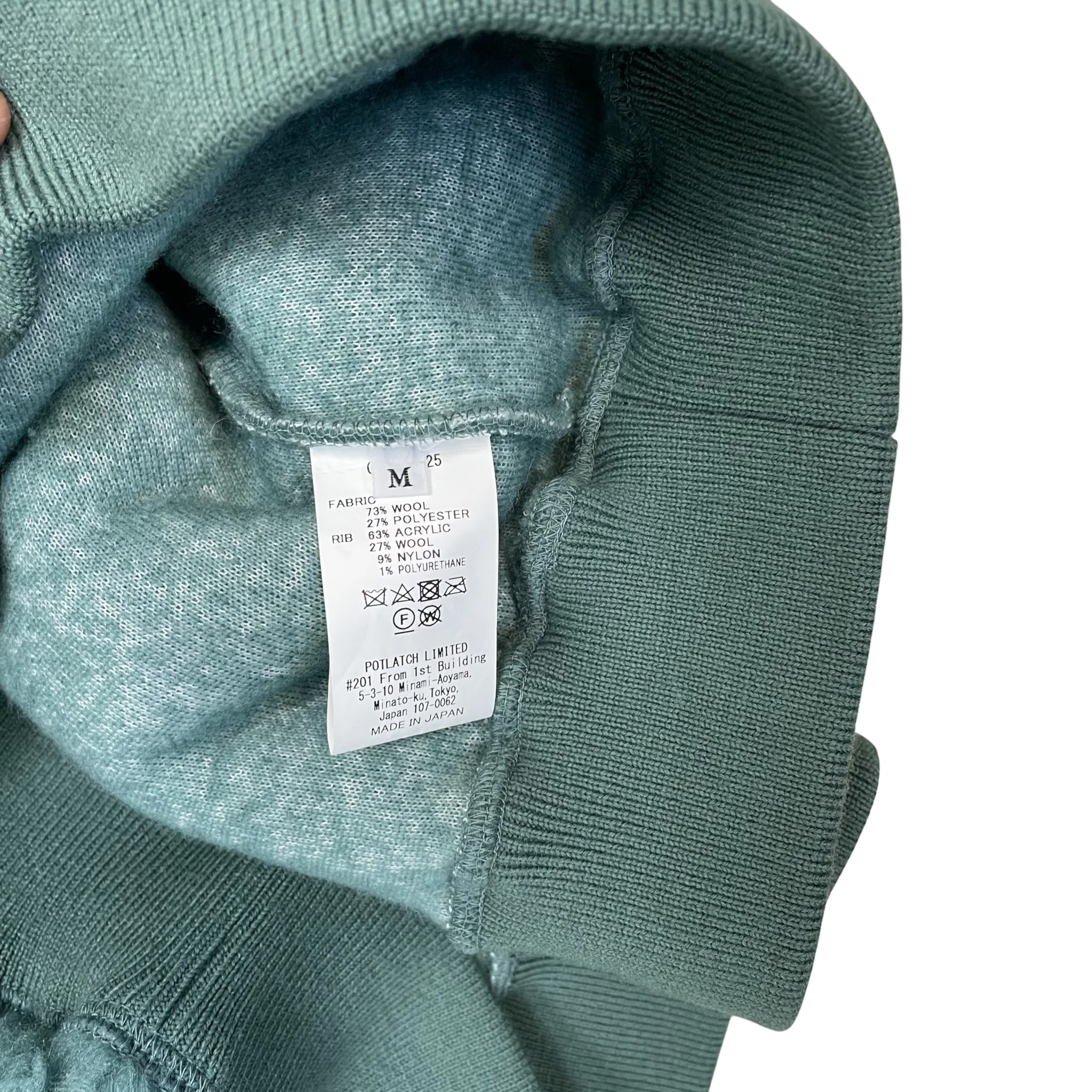Zenno Archive Cav Empt AW23 turquoise fleece pullover interior care label showing wool blend fabric composition