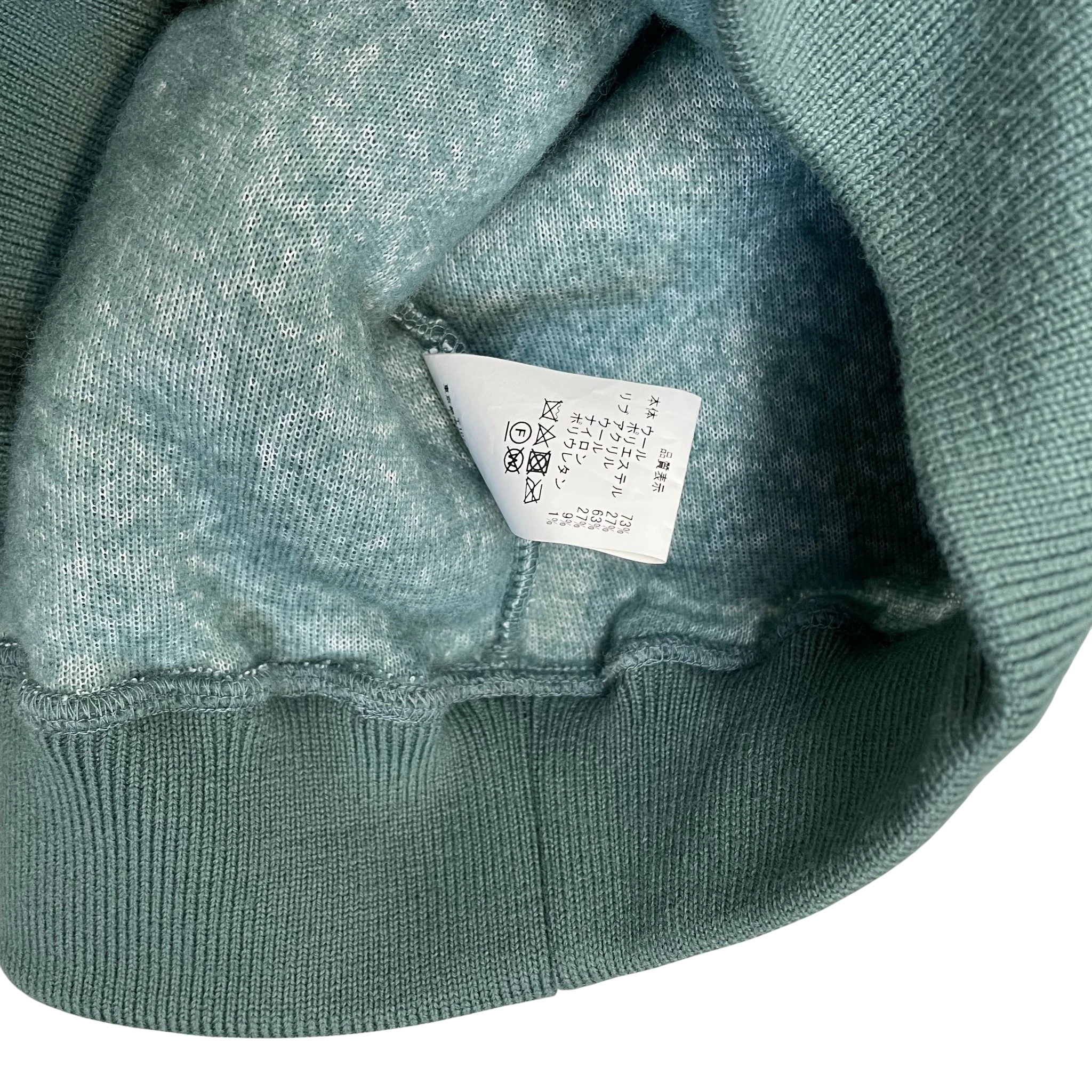 Zenno Archive Cav Empt AW23 turquoise fleece pullover interior care label and ribbed hem detail
