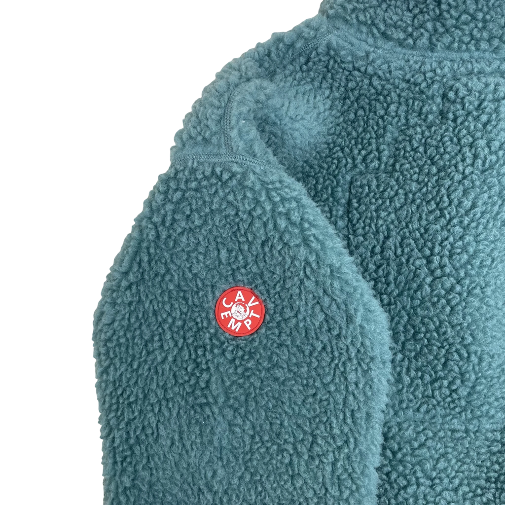 Zenno Archive Cav Empt turquoise fleece pullover with red circular logo patch on the sleeve