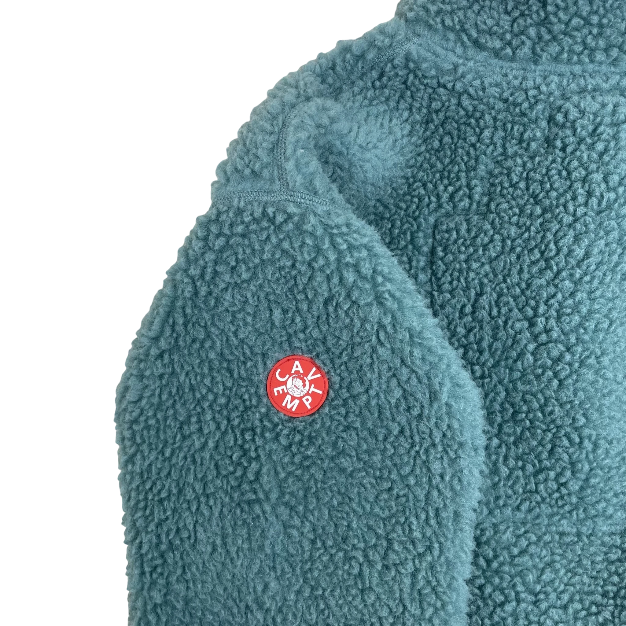 Zenno Archive Cav Empt turquoise fleece pullover with red circular logo patch on the sleeve