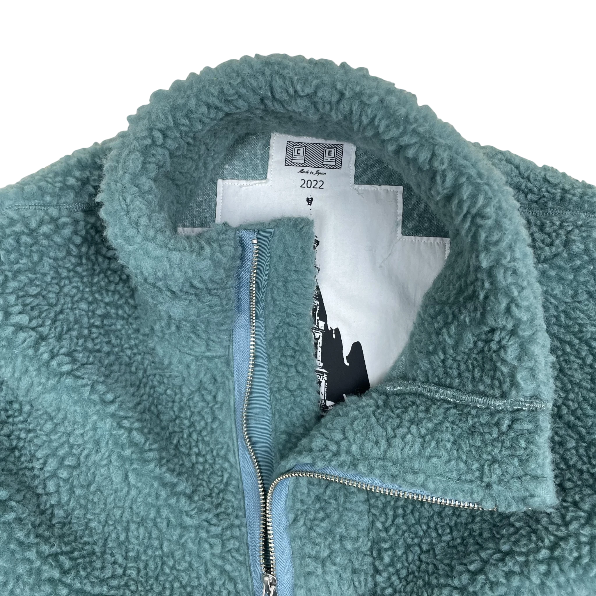 Zenno Archive Cav Empt turquoise fleece pullover with asymmetric zip closure and interior graphic label detail