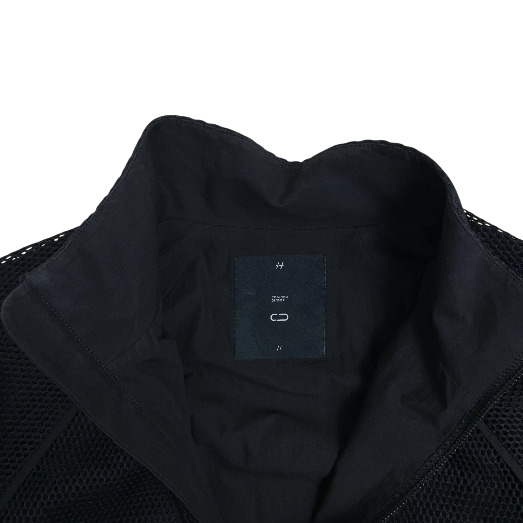 Zenno Archive Common Divisor black contour jacket featuring a structured collar and mesh paneling details.