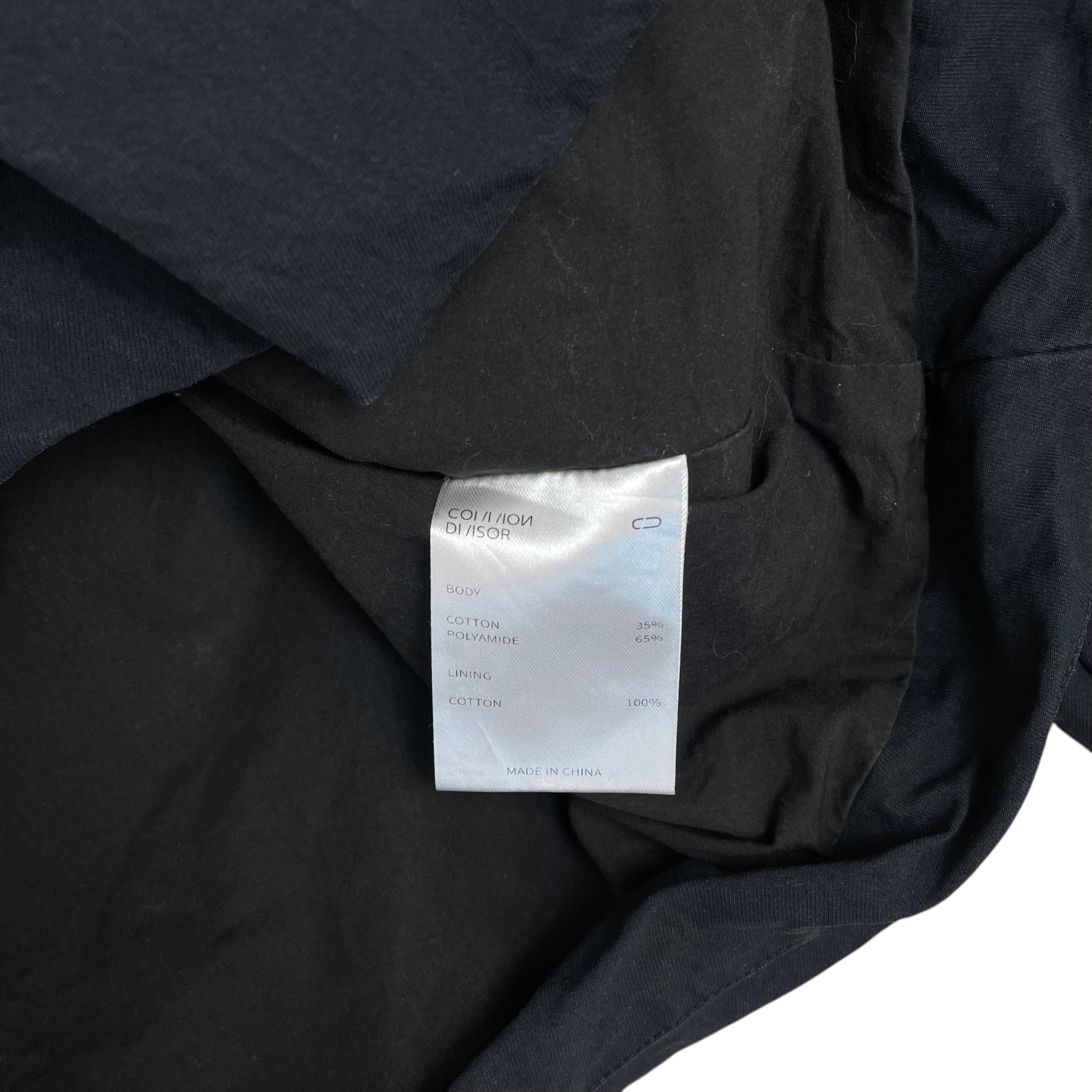 Zenno Archive Common Divisor Vale stand collar jacket black fabric care label showing cotton and polyamide blend