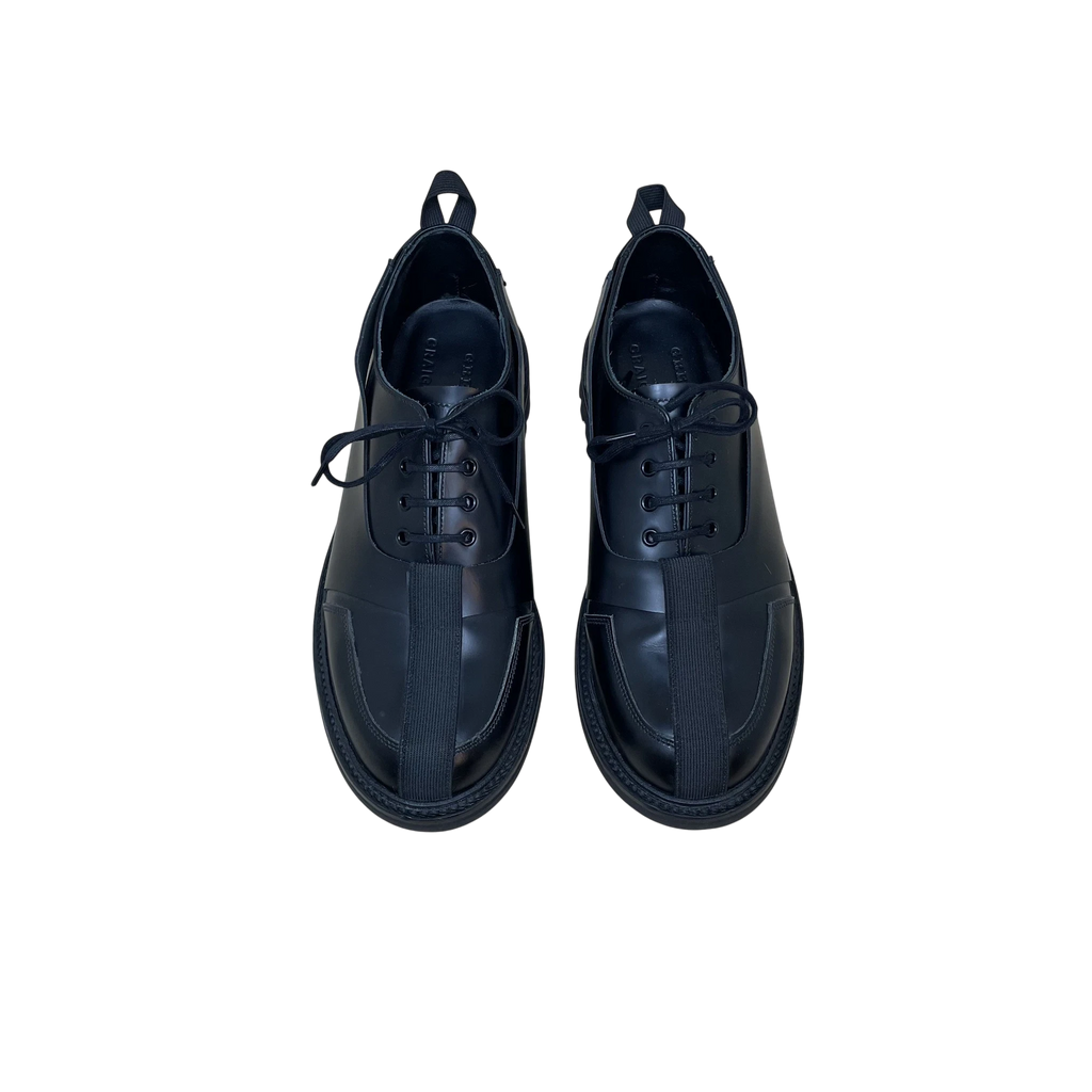 Zenno Archive Craig Green x Grenson black leather Oxford Derby shoes with central strap detail and lace-up closure.