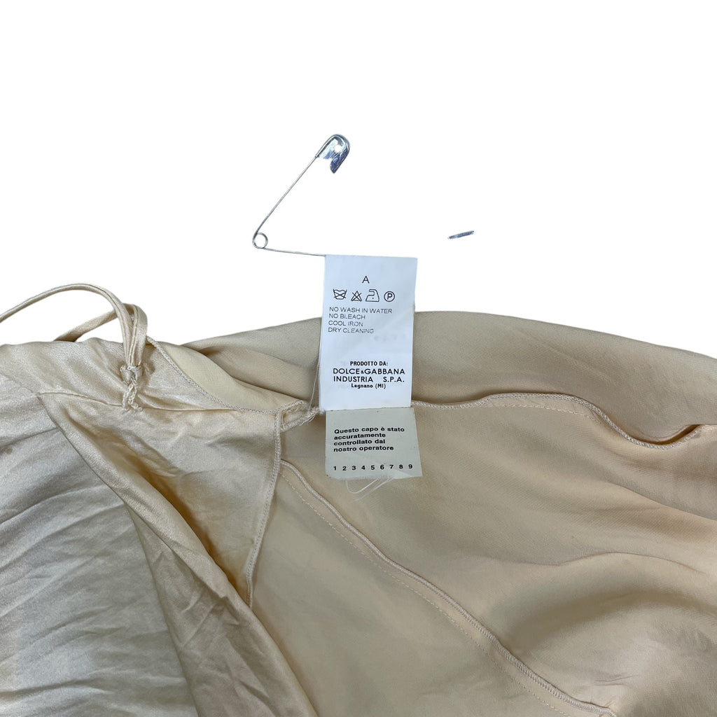 Zenno Archive Dolce & Gabbana silk dress care label and safety pin detail on a textured white background