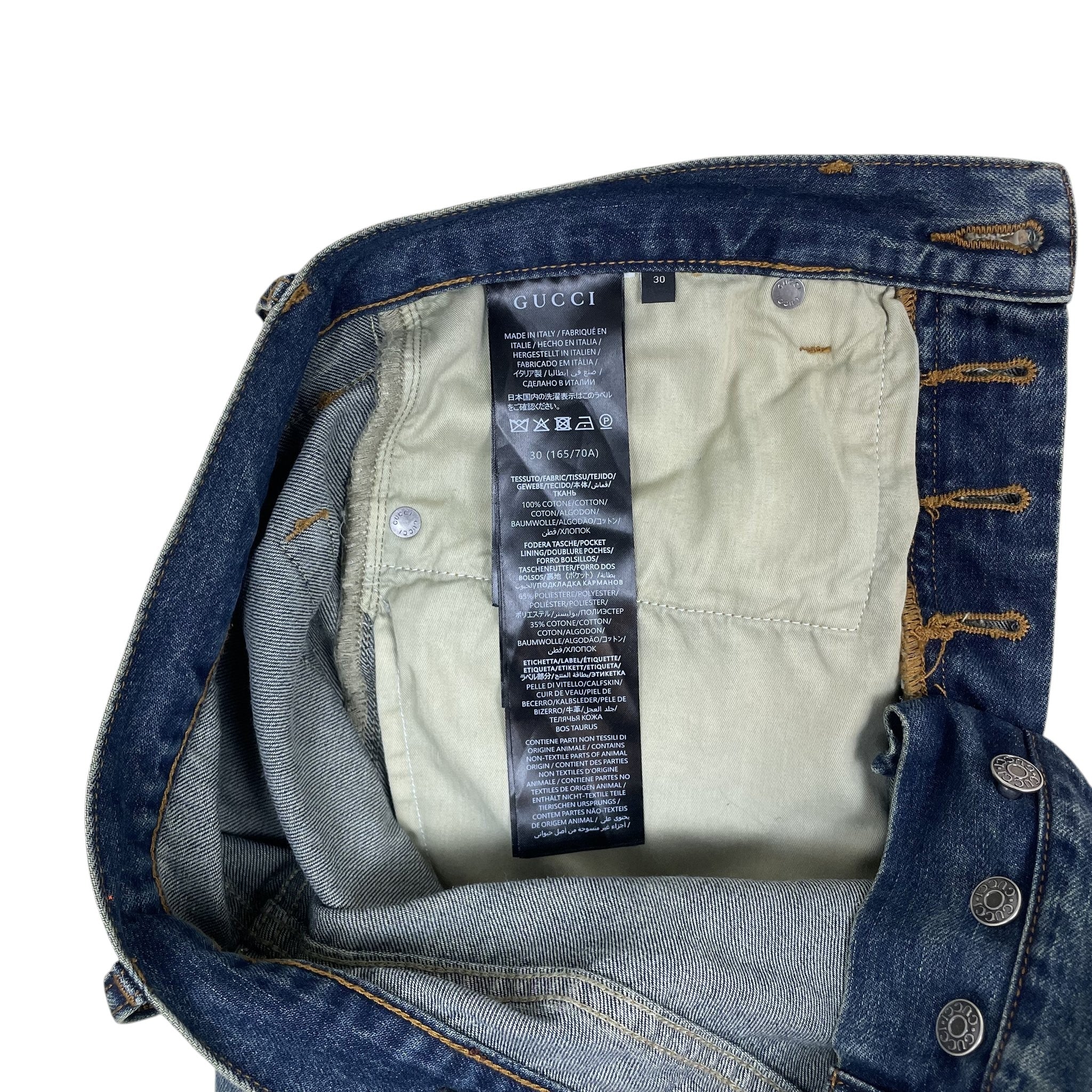 Zenno Archive Gucci AW25 Horsebit jeans in washed blue denim showing the interior care label and branded buttons.