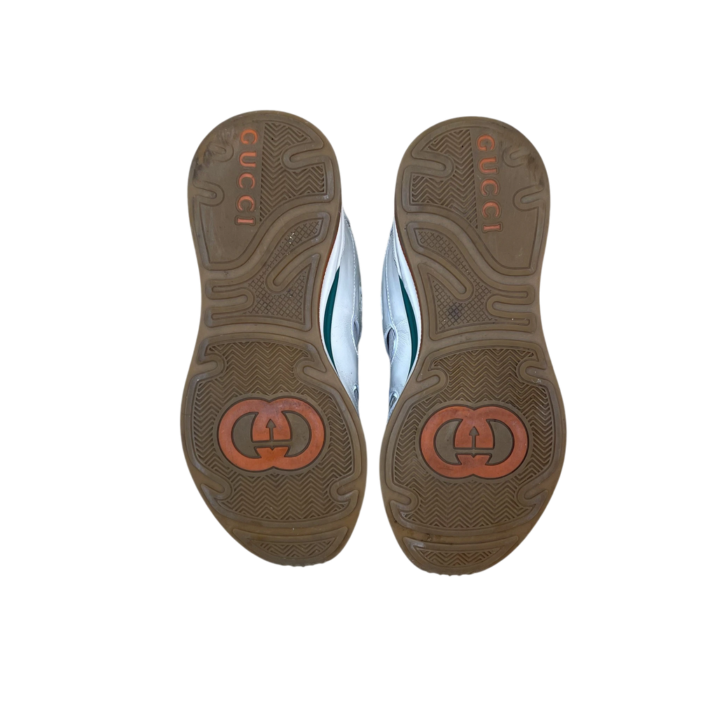 Zenno Archive Gucci Ultrapace sneakers showing the brown rubber outsoles with embossed Gucci branding and logos.