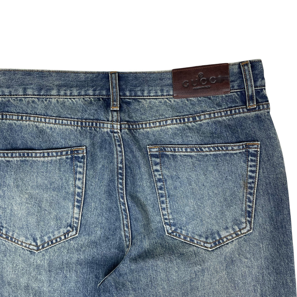 Zenno Archive Gucci AW25 washed blue denim jeans featuring a brown leather logo patch on the back waistband.