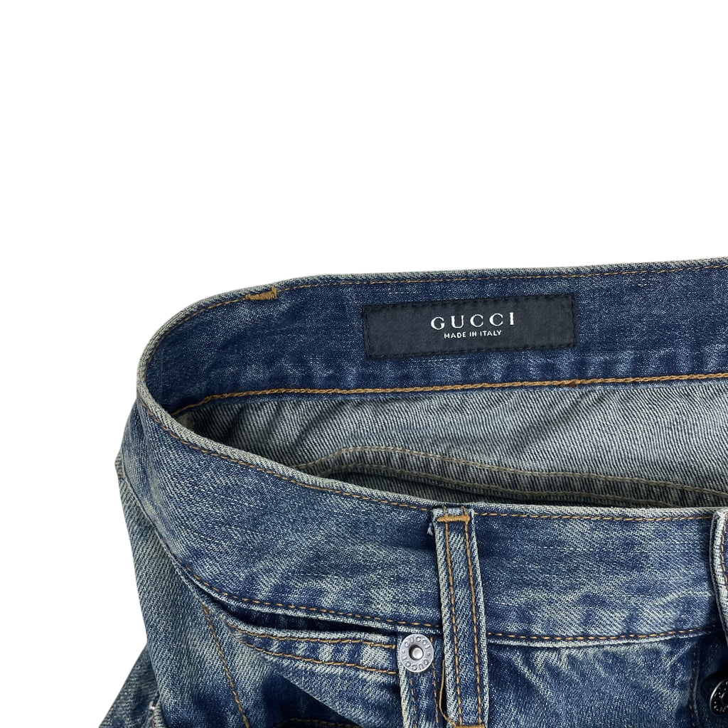 Zenno Archive Gucci AW25 washed blue denim jeans featuring a branded waistband label and metal button detail.