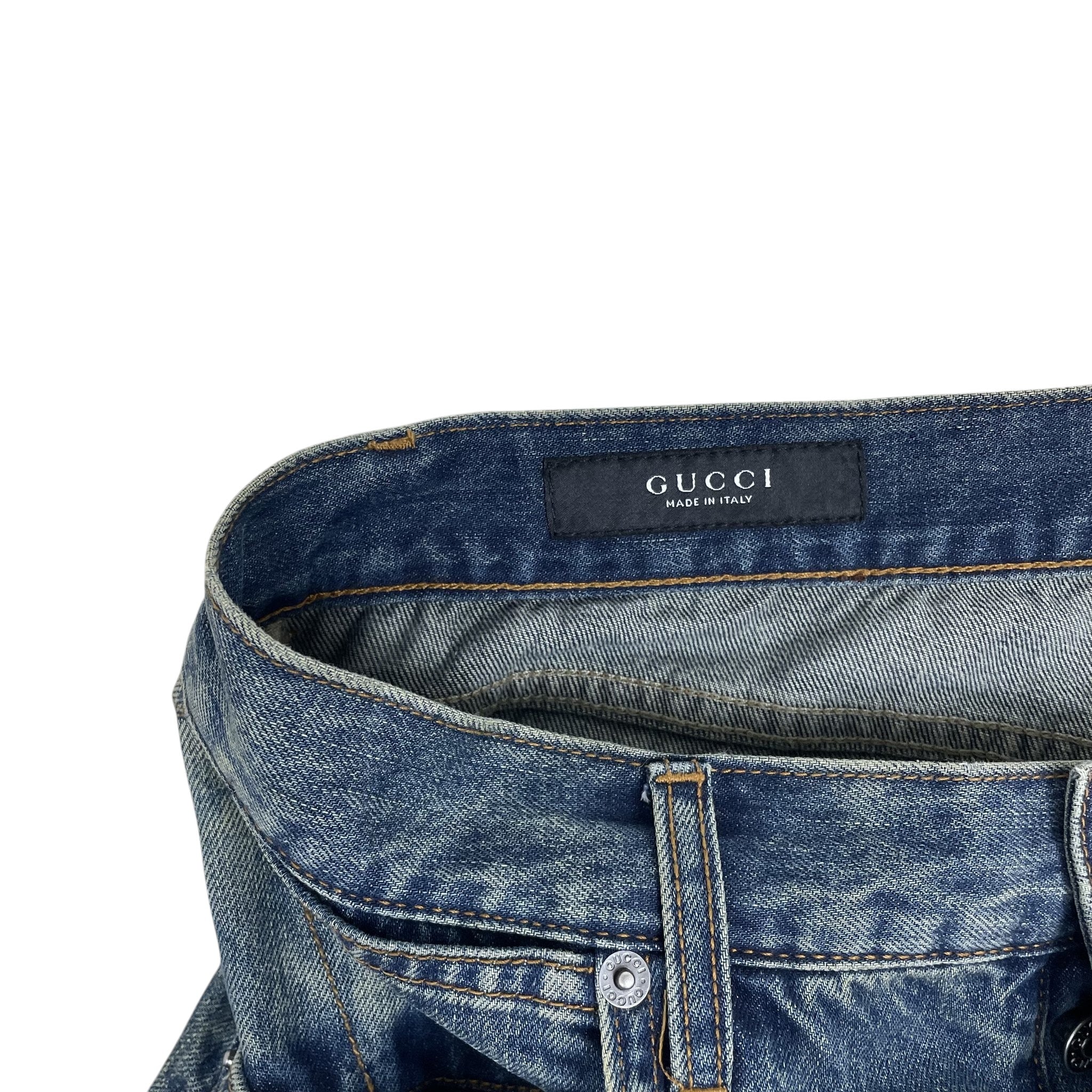 Zenno Archive Gucci AW25 washed blue denim jeans featuring a branded waistband label and metal button detail.
