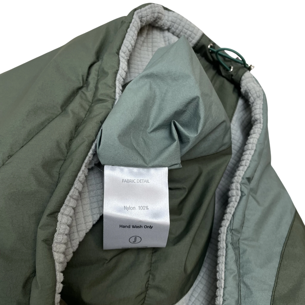 Zenno Archive Jeong Li reversible vest in olive green nylon with grey textured lining and care label detail