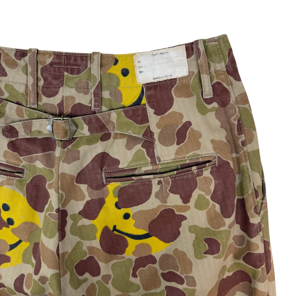 Zenno Archive Kapital herringbone camouflage pants with yellow smiley face peek-a-boo details and back cinch buckle