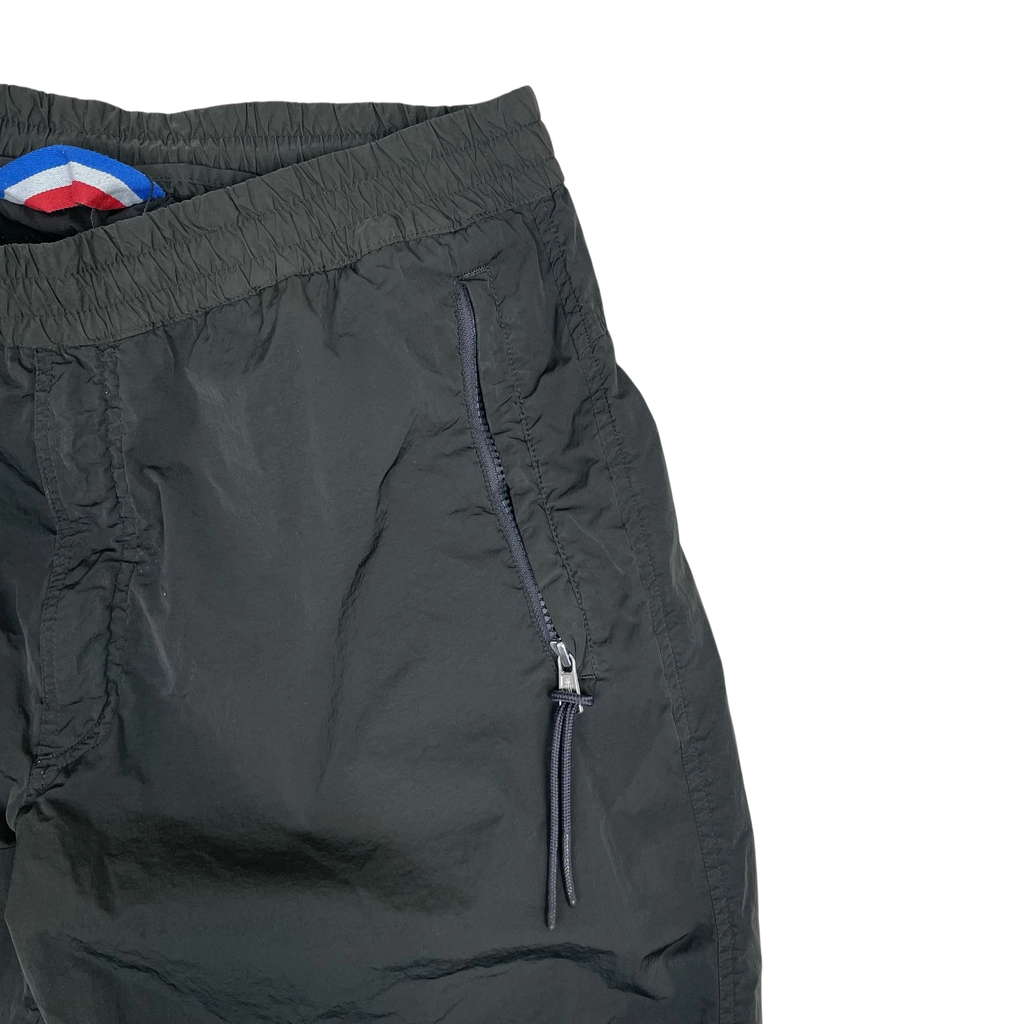 Zenno Archive Moncler 1952 dark green nylon pants featuring an elastic waistband and zippered side pocket.