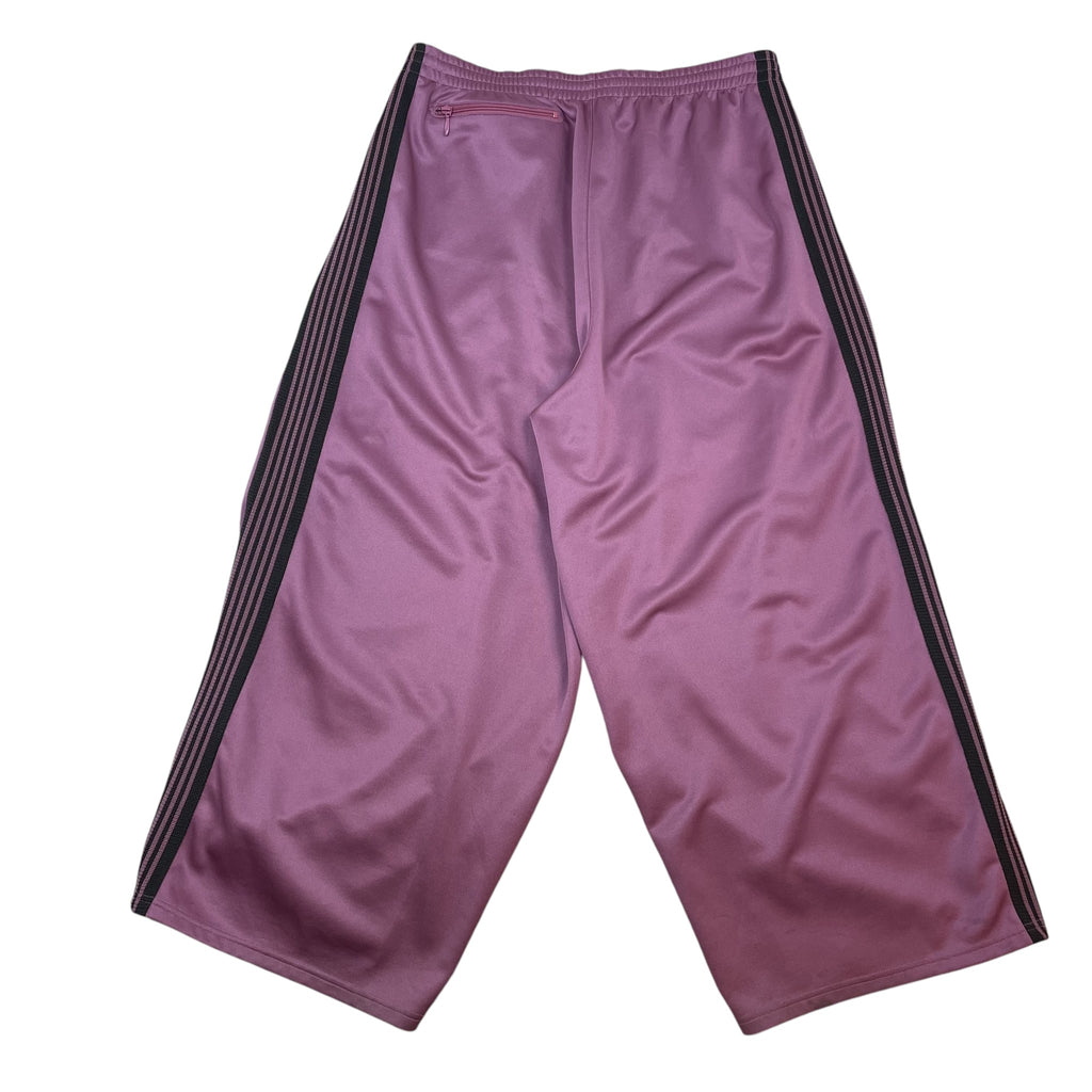 Zenno Archive Needles H.D. track pants in pink featuring a wide-leg silhouette, black side stripes, and back pocket.