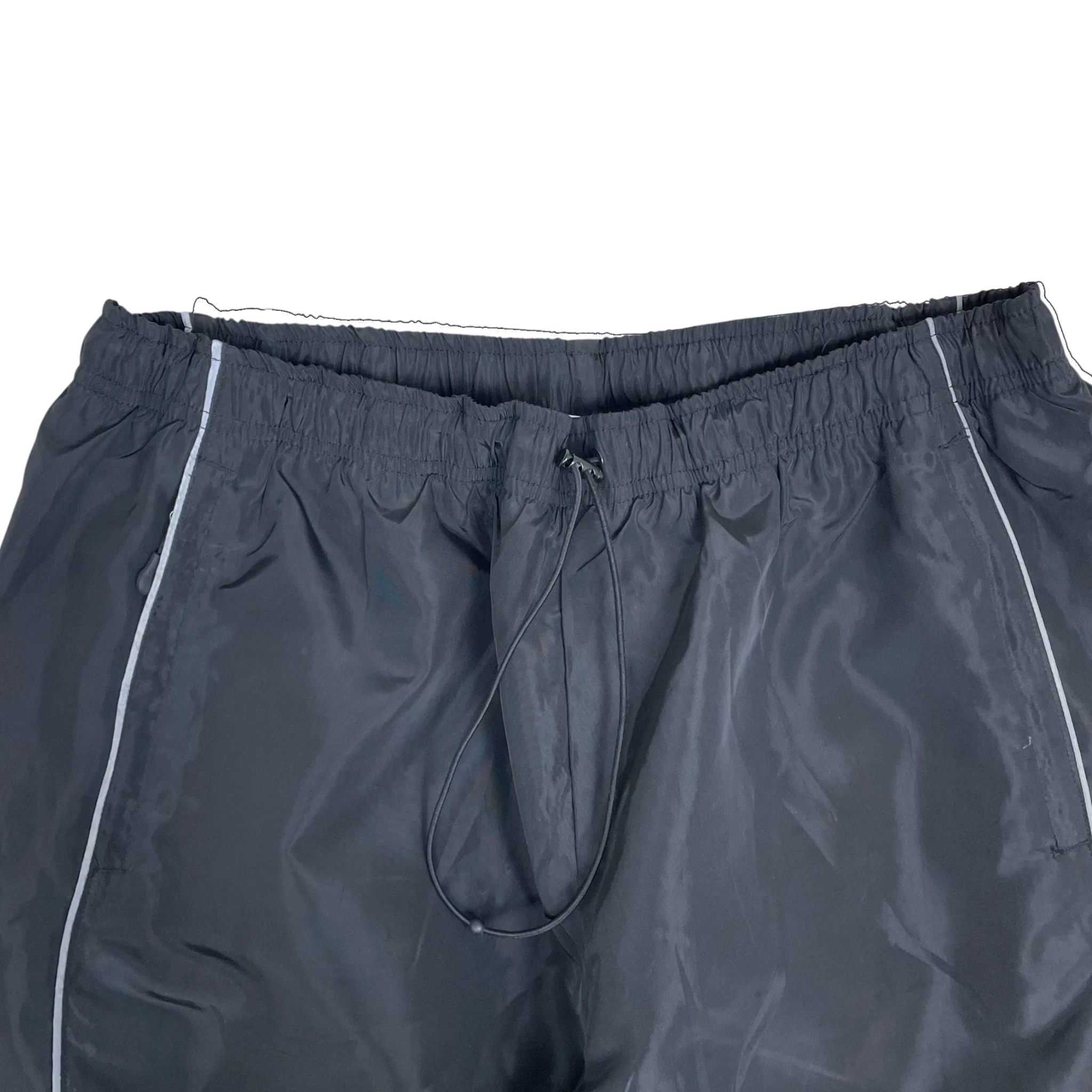 Zenno Archive Nike x Corteiz black track pants with reflective 3M piping detail and an elastic drawstring waistband.