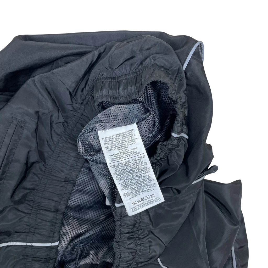 Zenno Archive Nike x Corteiz black track pants featuring 3M reflective piping and interior care label detail