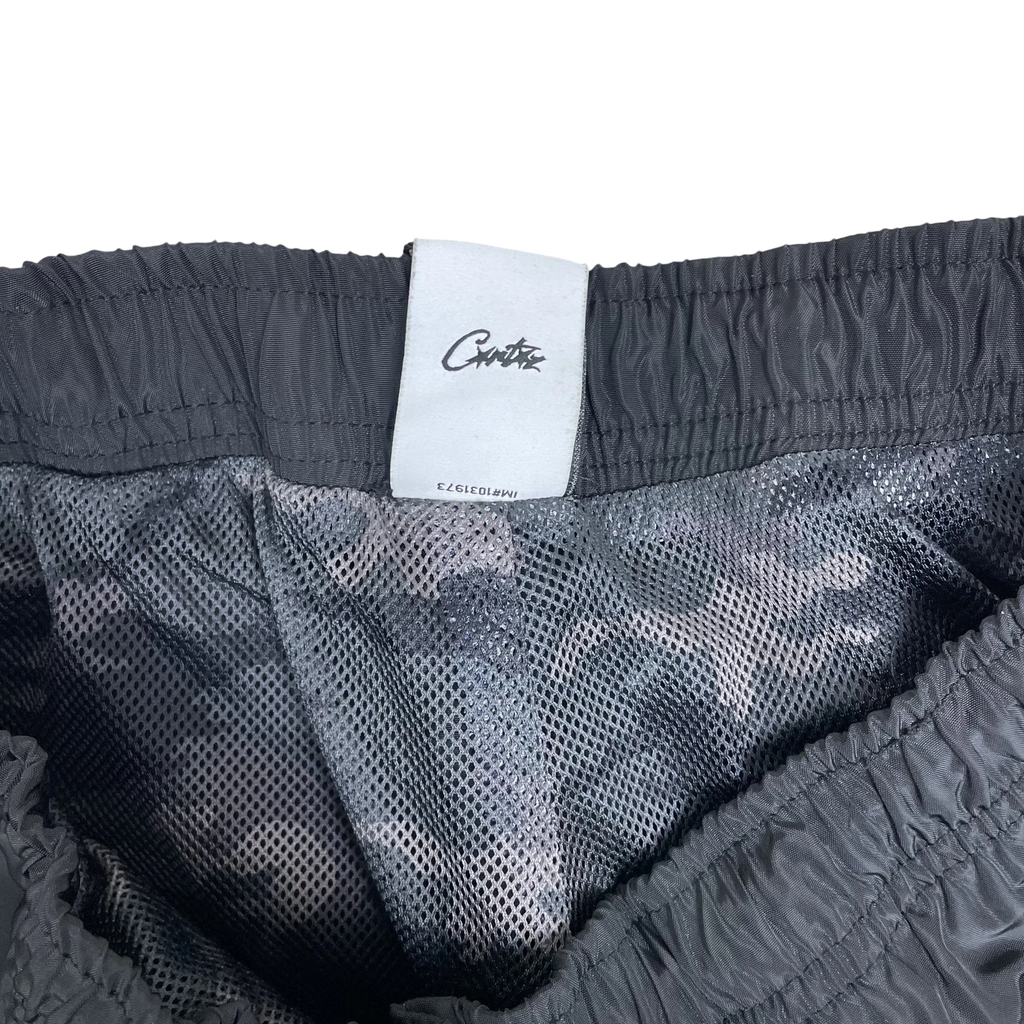 Zenno Archive Nike x Corteiz black track pants featuring a white interior brand label and camo mesh lining
