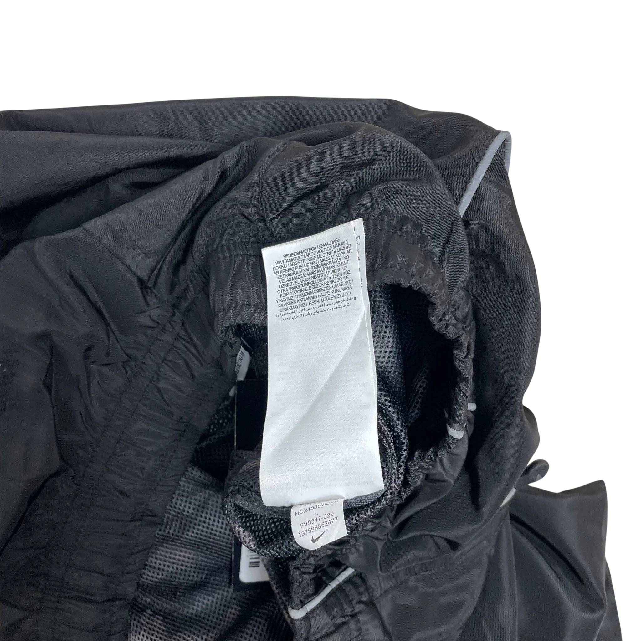 Zenno Archive Nike x Corteiz black track pants interior tag and mesh lining detail