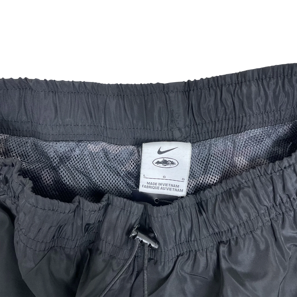 Zenno Archive Nike x Corteiz black track pants featuring an elastic waistband and interior size L branding tag