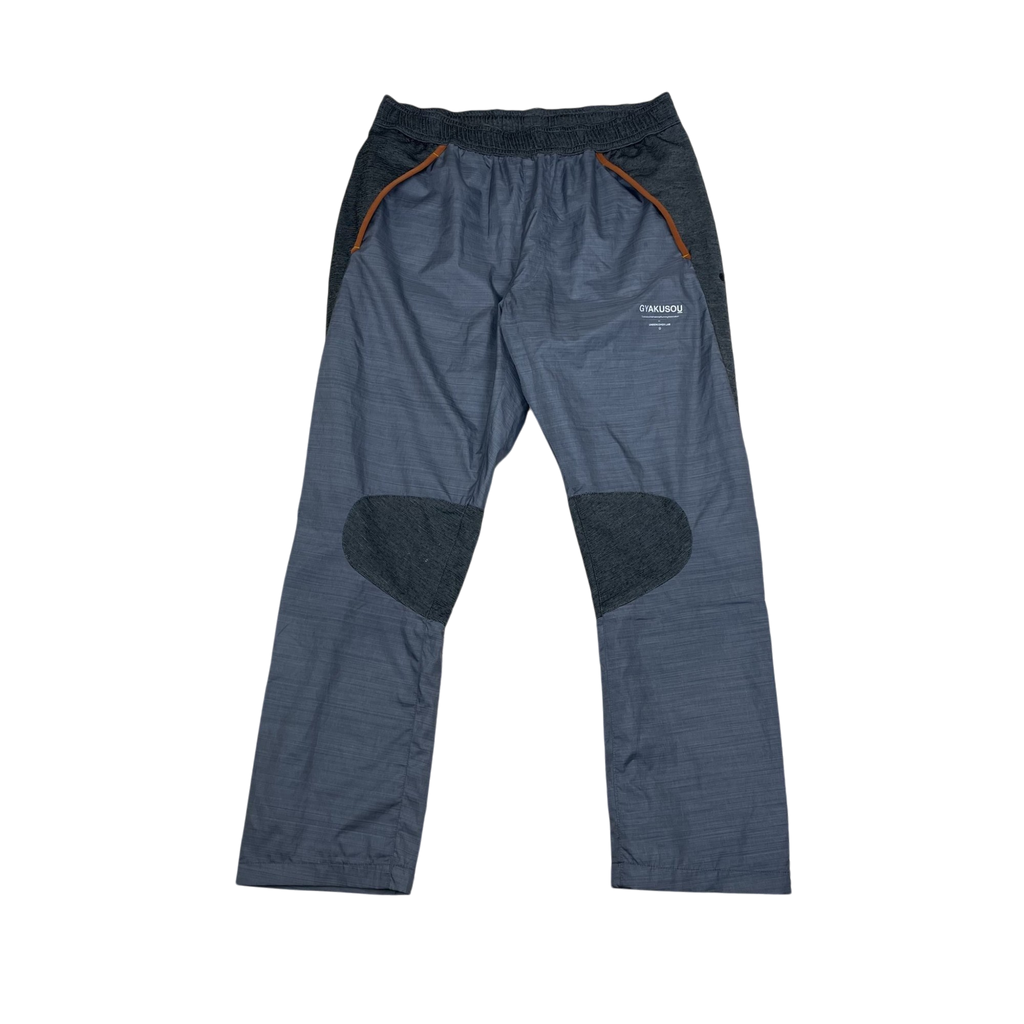 Zenno Archive Nike x Undercover Gyakusou technical running pants in grey with contrast knee patches and orange trim.
