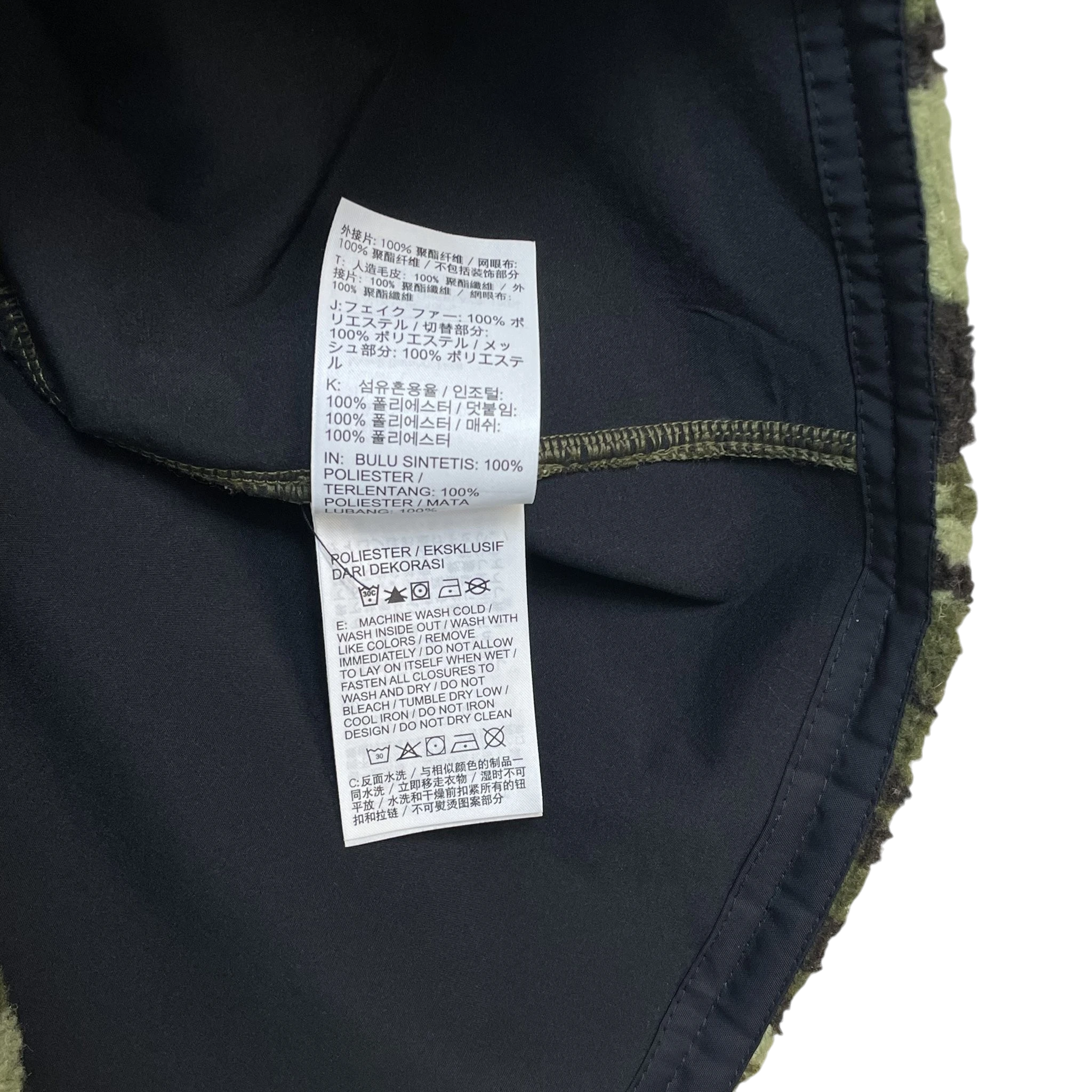 Zenno Archive Nike x MMW fleece jacket interior care label with washing instructions in multiple languages