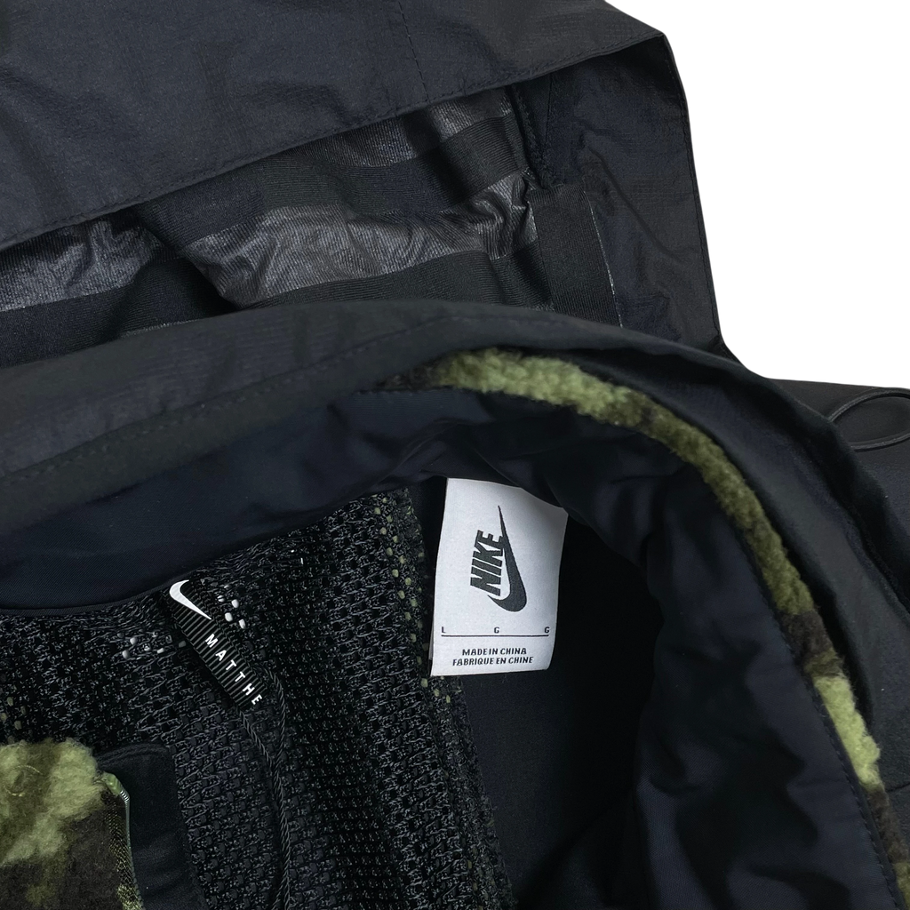 Zenno Archive Nike x MMW fleece jacket interior featuring black mesh lining, camo green fleece, and Nike brand label.
