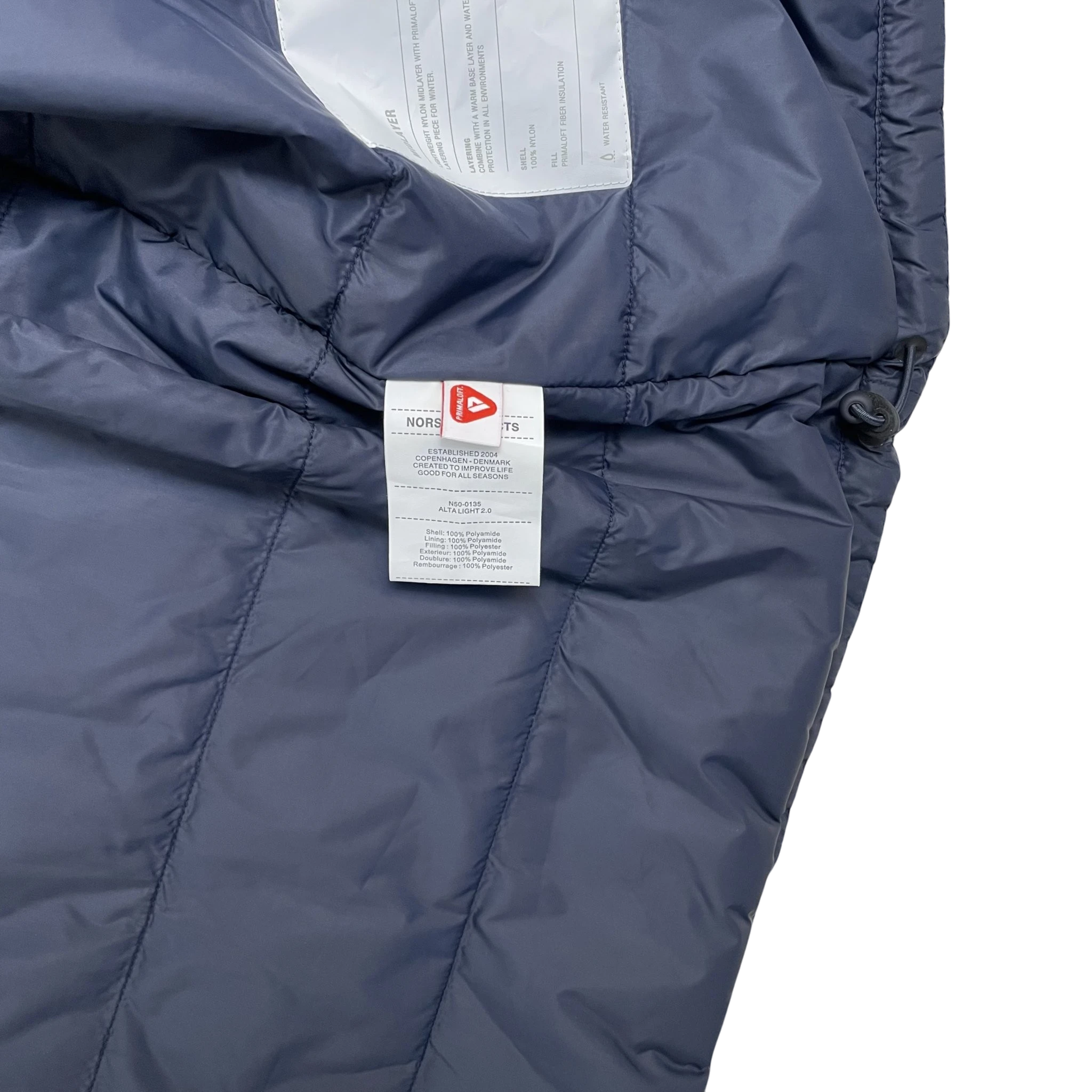 Zenno Archive Norse Projects navy insulated waterproof jacket interior label with Primaloft insulation details