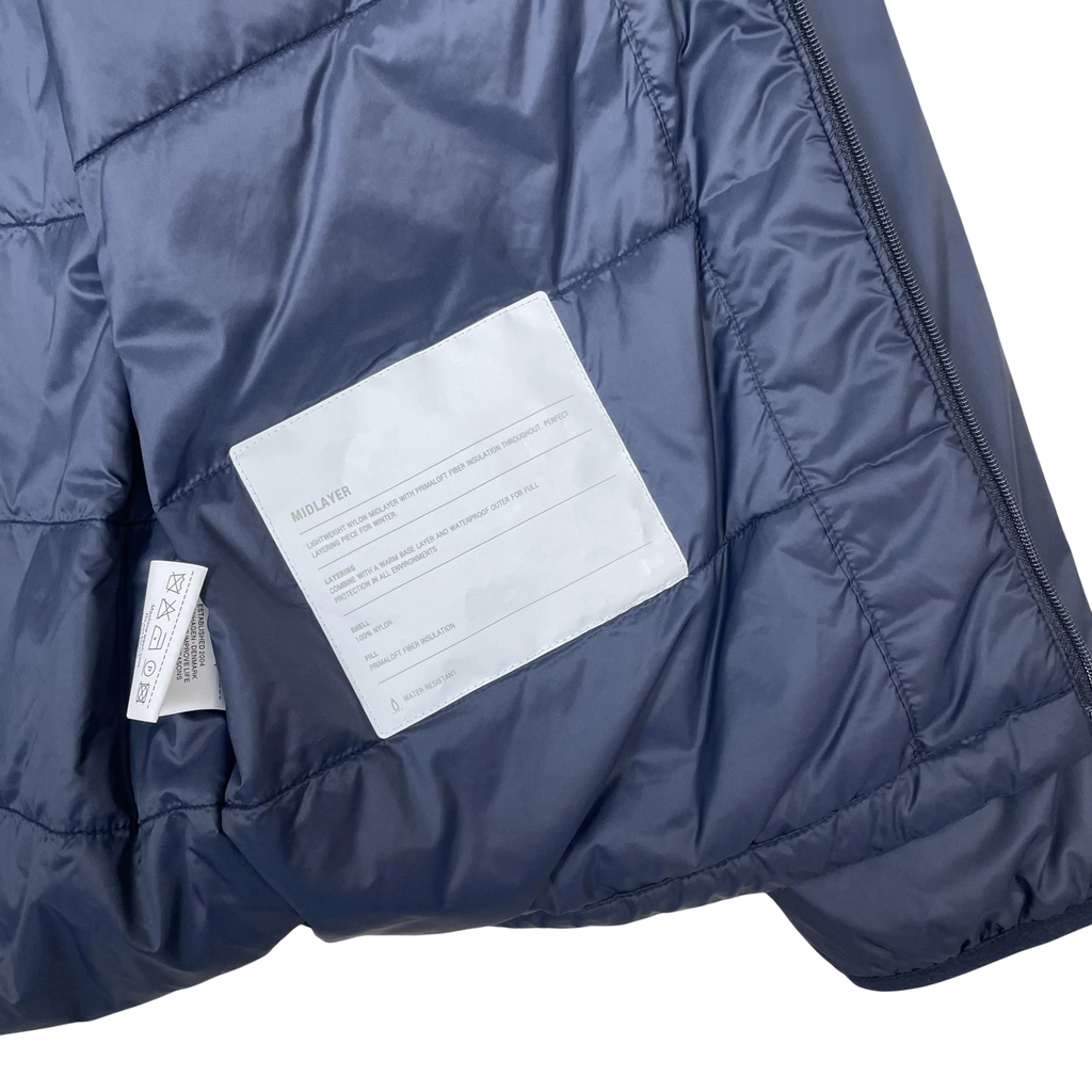 Zenno Archive Norse Projects navy insulated waterproof jacket interior label with Primaloft fiber insulation details
