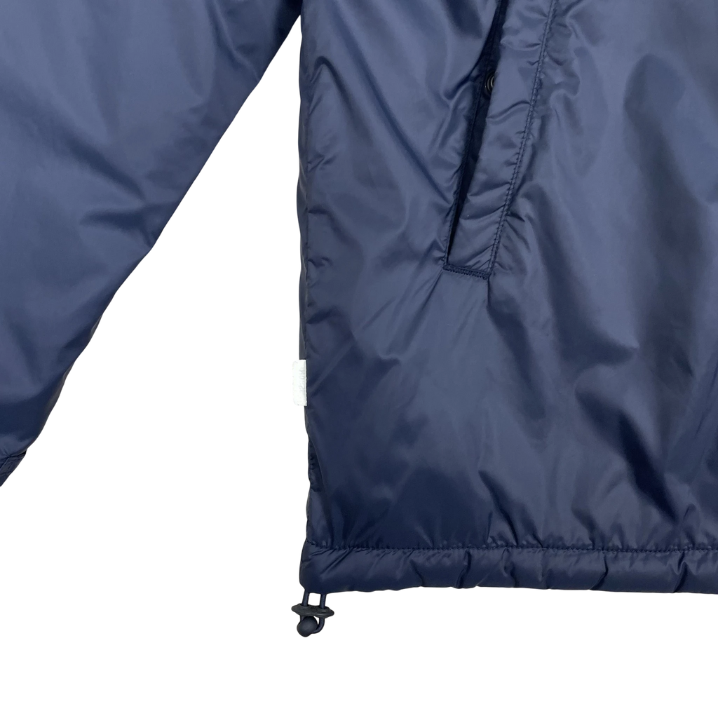 Zenno Archive Norse Projects navy insulated waterproof jacket featuring a side pocket and adjustable drawstring hem.