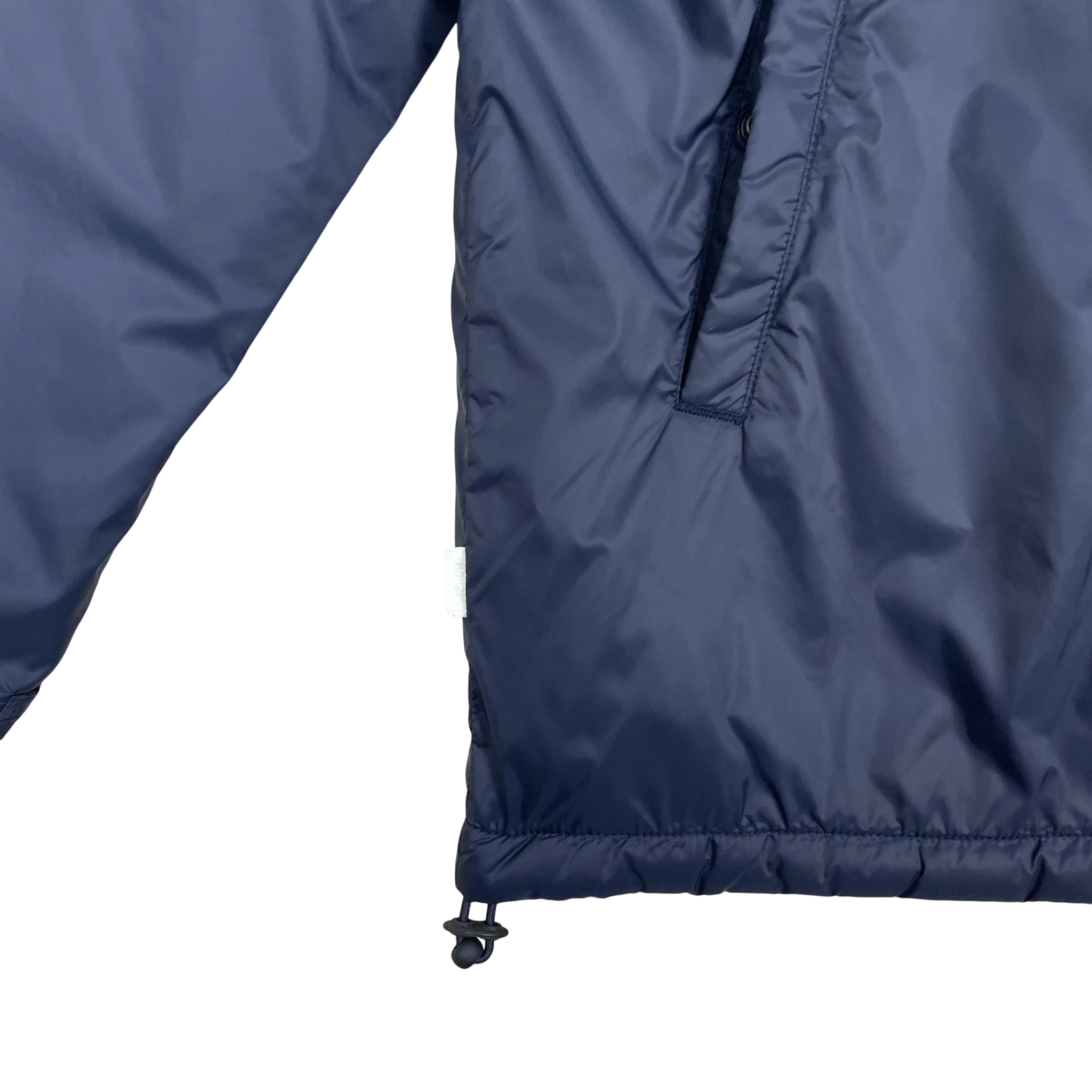Zenno Archive Norse Projects navy insulated waterproof jacket featuring a side pocket and adjustable drawstring hem.