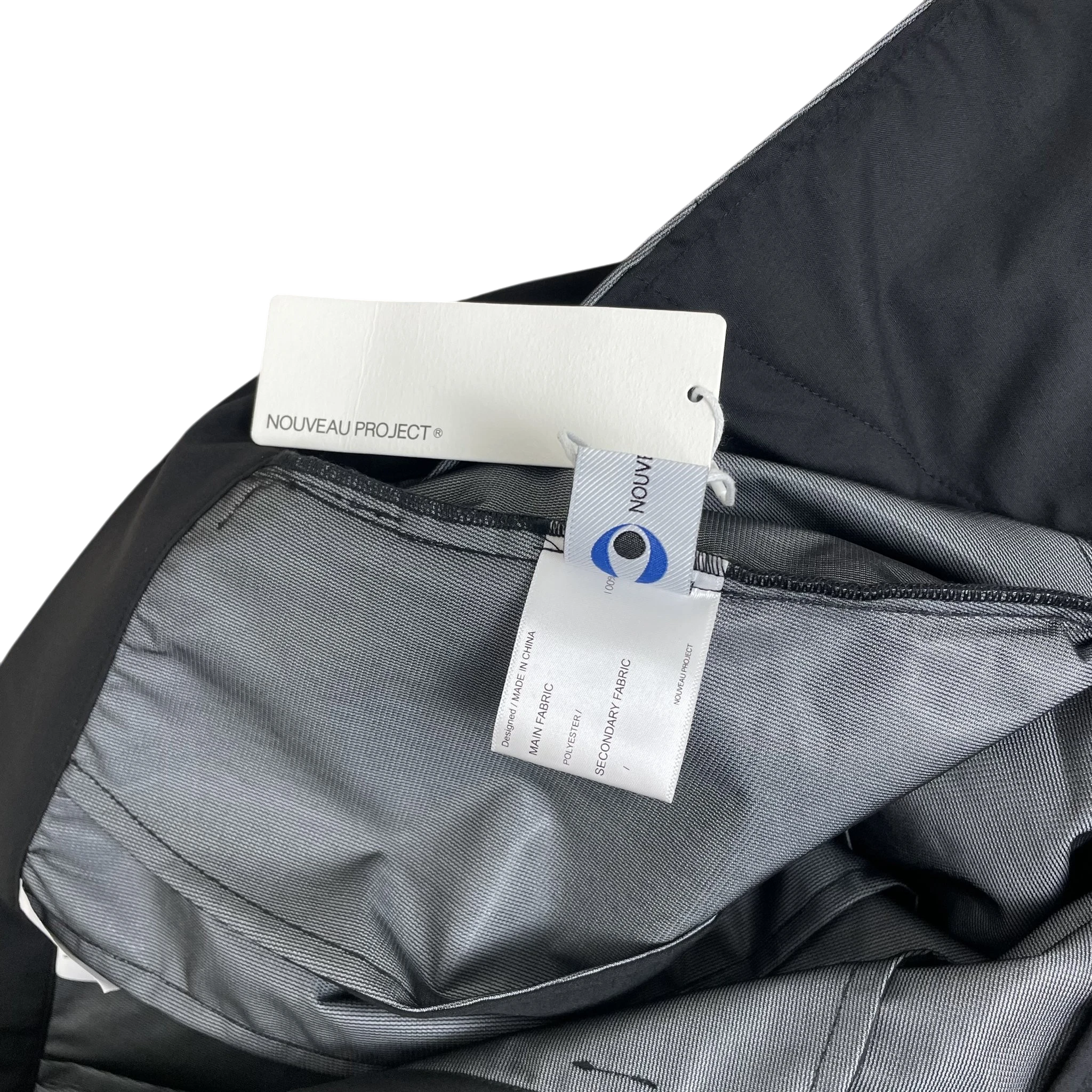 Zenno Archive Nouveau Project technical trousers with black fabric, pocket flap, and brand tags attached