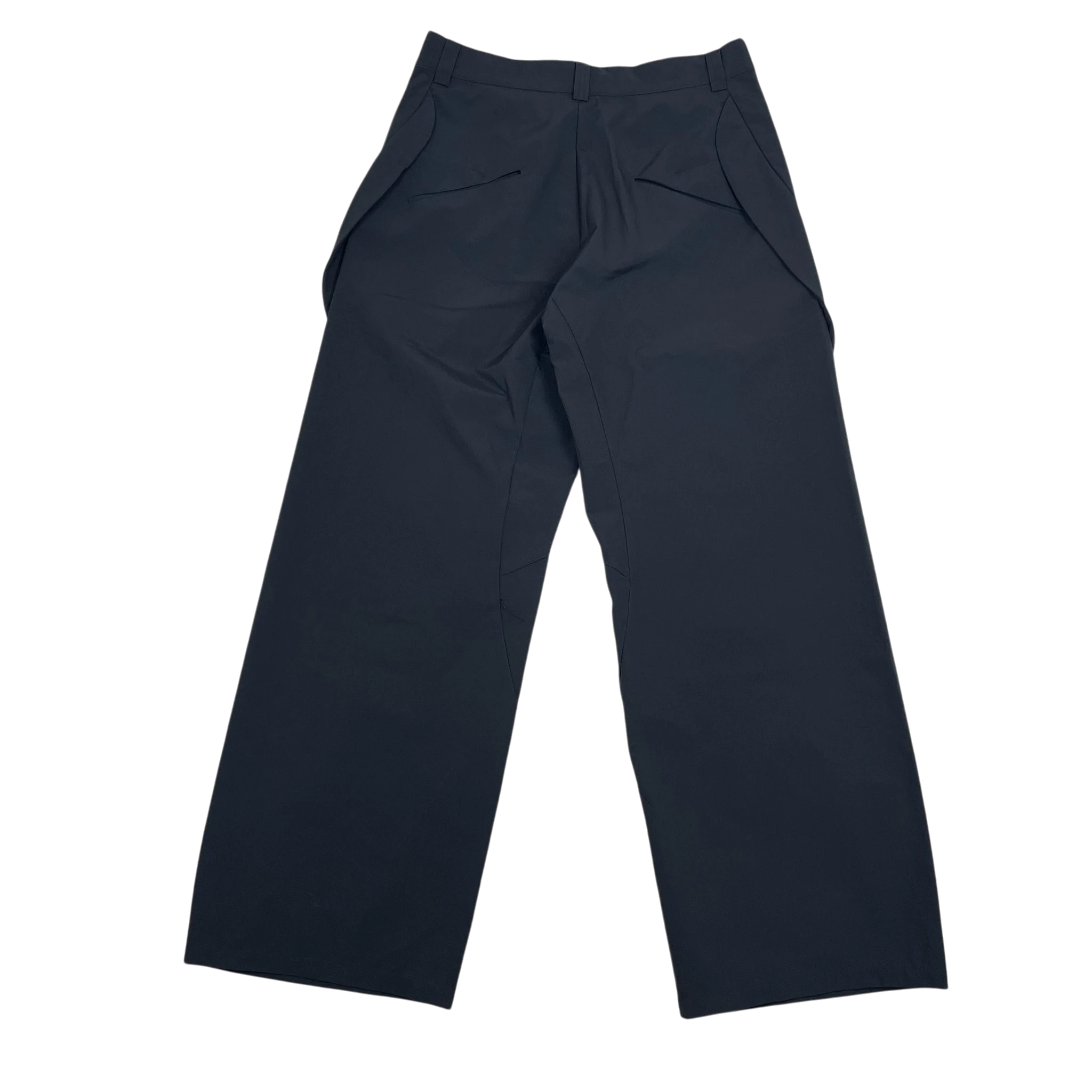 Zenno Archive Nouveou Project black technical trousers with unique pocket flap detailing on a textured background.