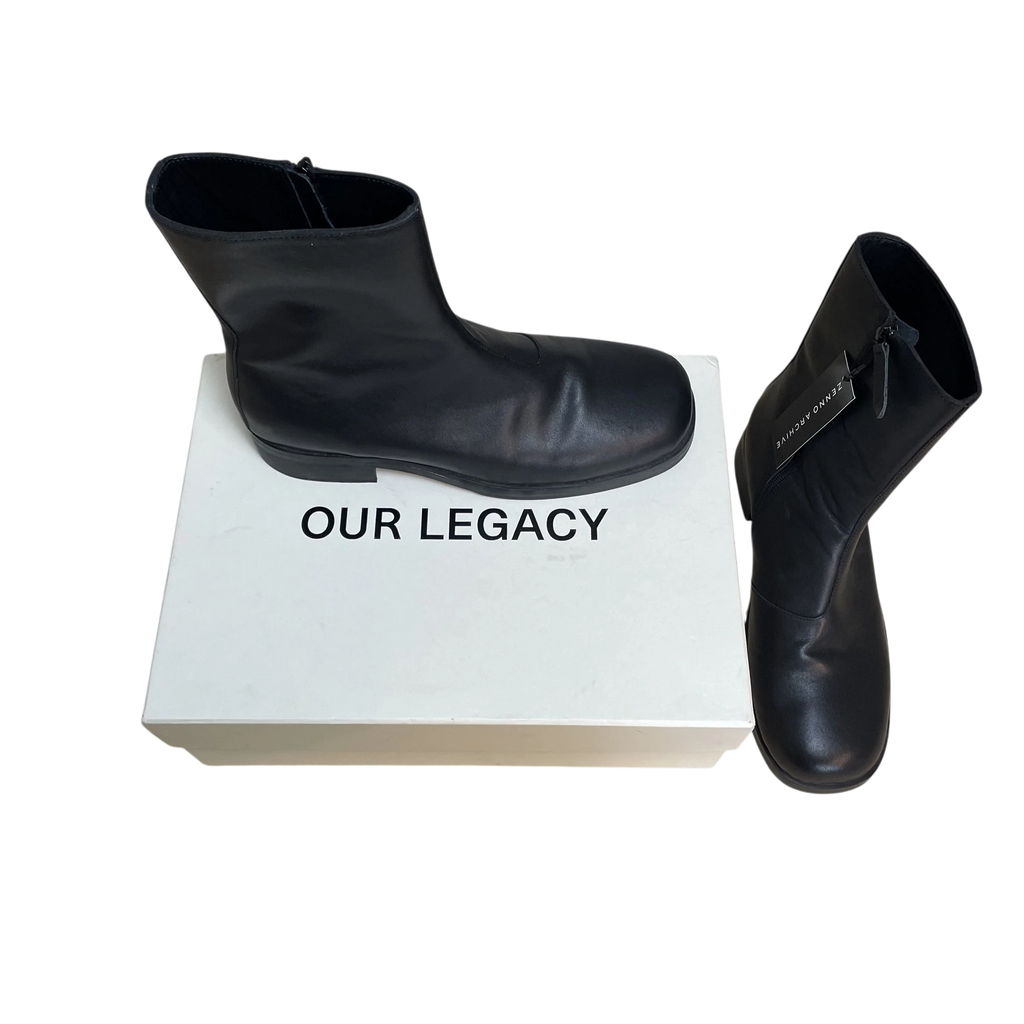 Zenno Archive Our Legacy black leather Camion boots with side zip closure displayed with original white shoe box