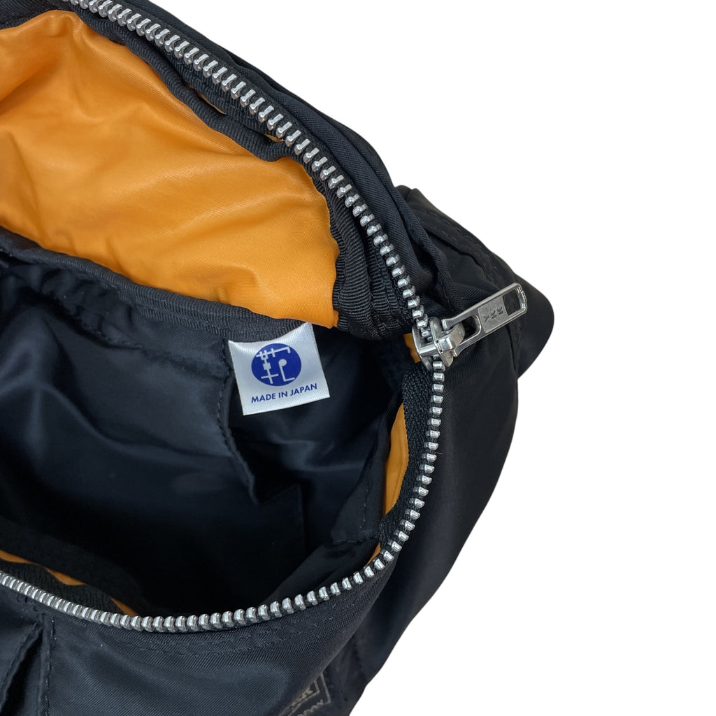 Zenno Archive Porter Tanker waist bag in black nylon with a bright orange interior lining and silver YKK zipper.
