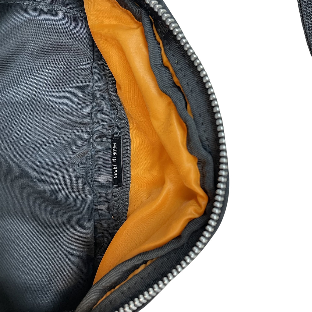 Zenno Archive Porter Tanker waist bag interior featuring black nylon exterior, bright orange lining, and Made in Japan tag