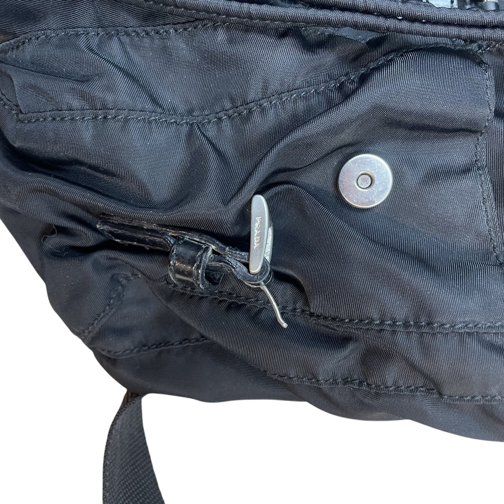 Zenno Archive Prada Tessuto Montagna black nylon backpack featuring a silver metal buckle and magnetic snap closure
