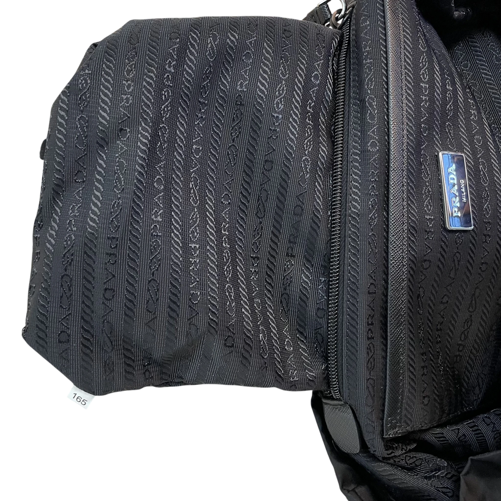 Zenno Archive Prada black nylon backpack interior featuring signature logo jacquard lining and metal brand plaque