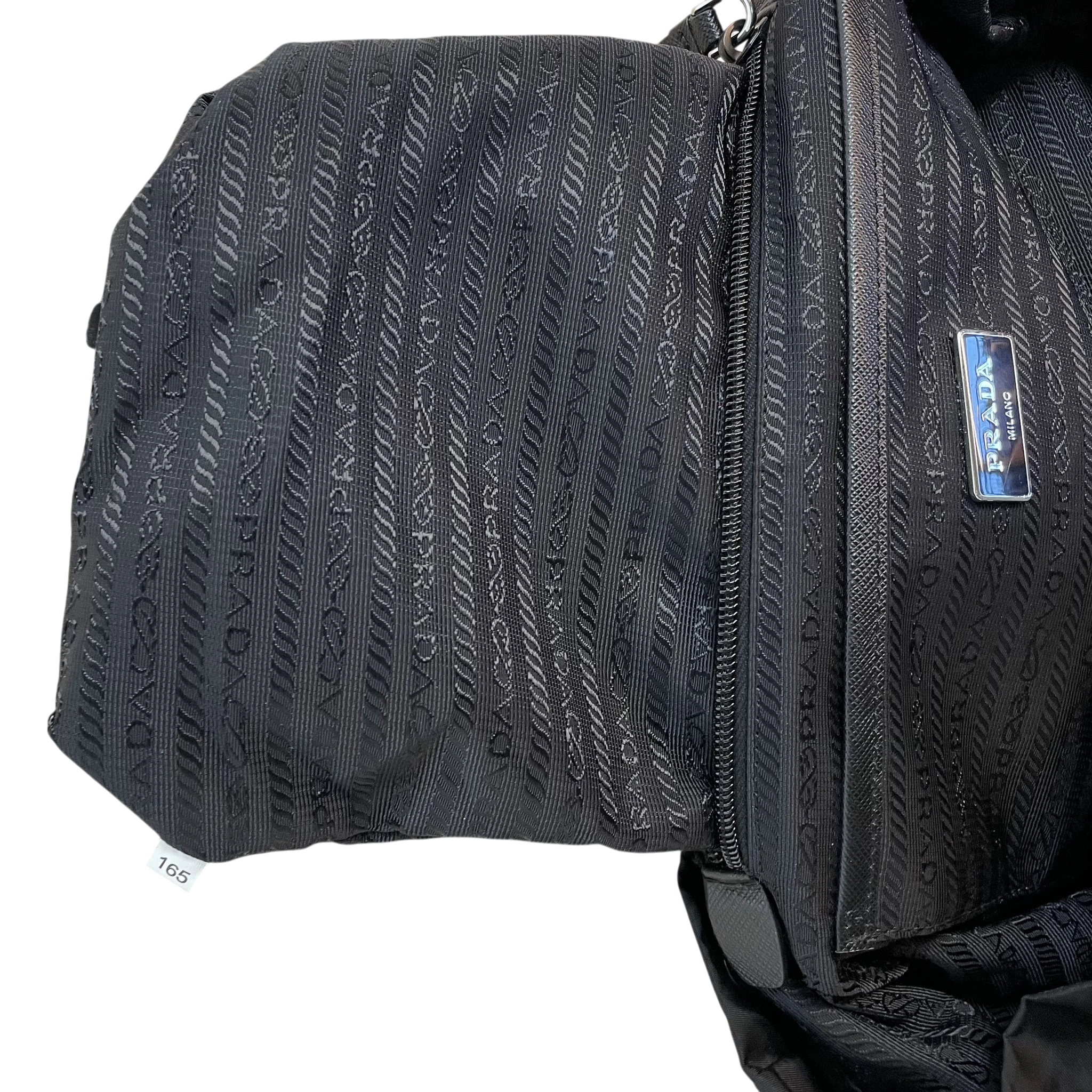 Zenno Archive Prada black nylon backpack interior featuring signature logo jacquard lining and metal brand plaque