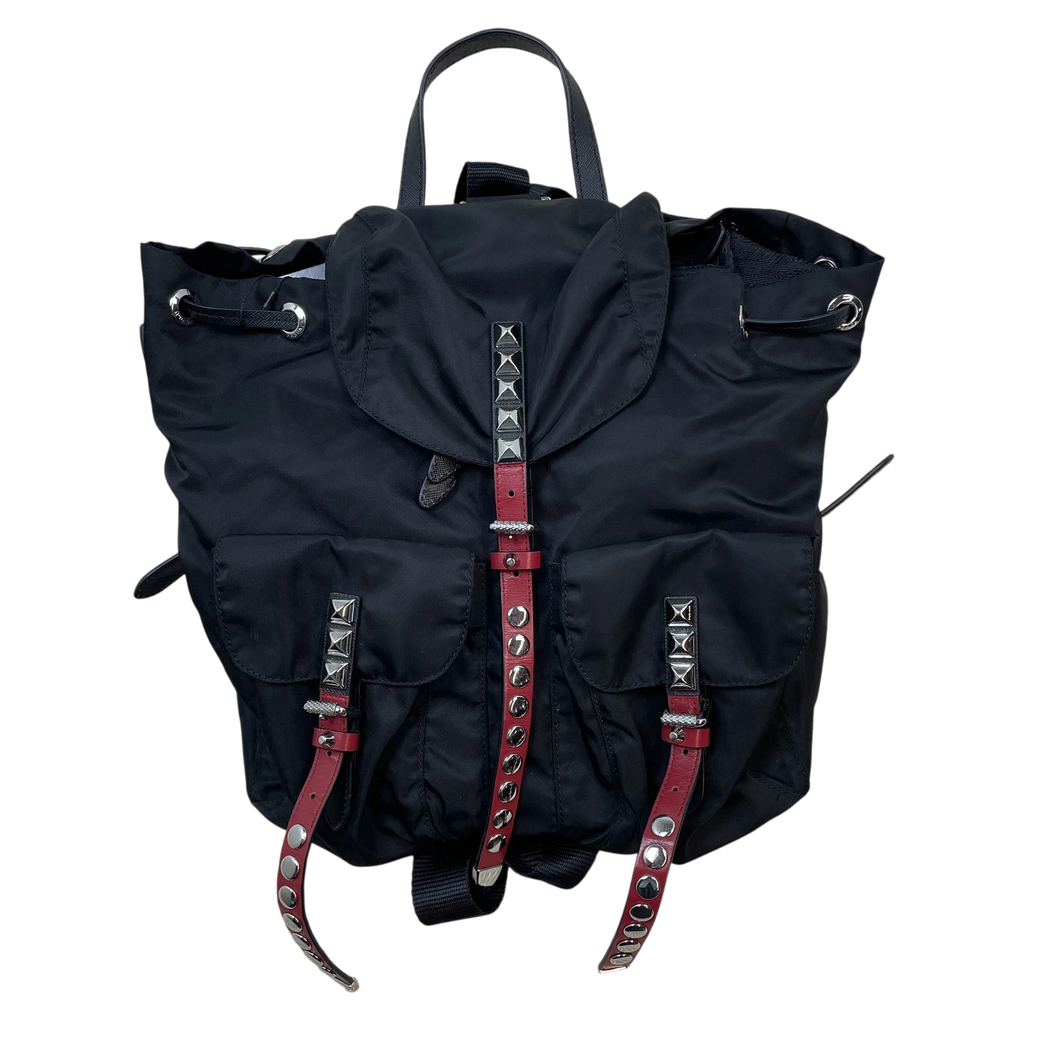 Zenno Archive Prada black nylon backpack featuring silver pyramid studs and red leather buckle straps.