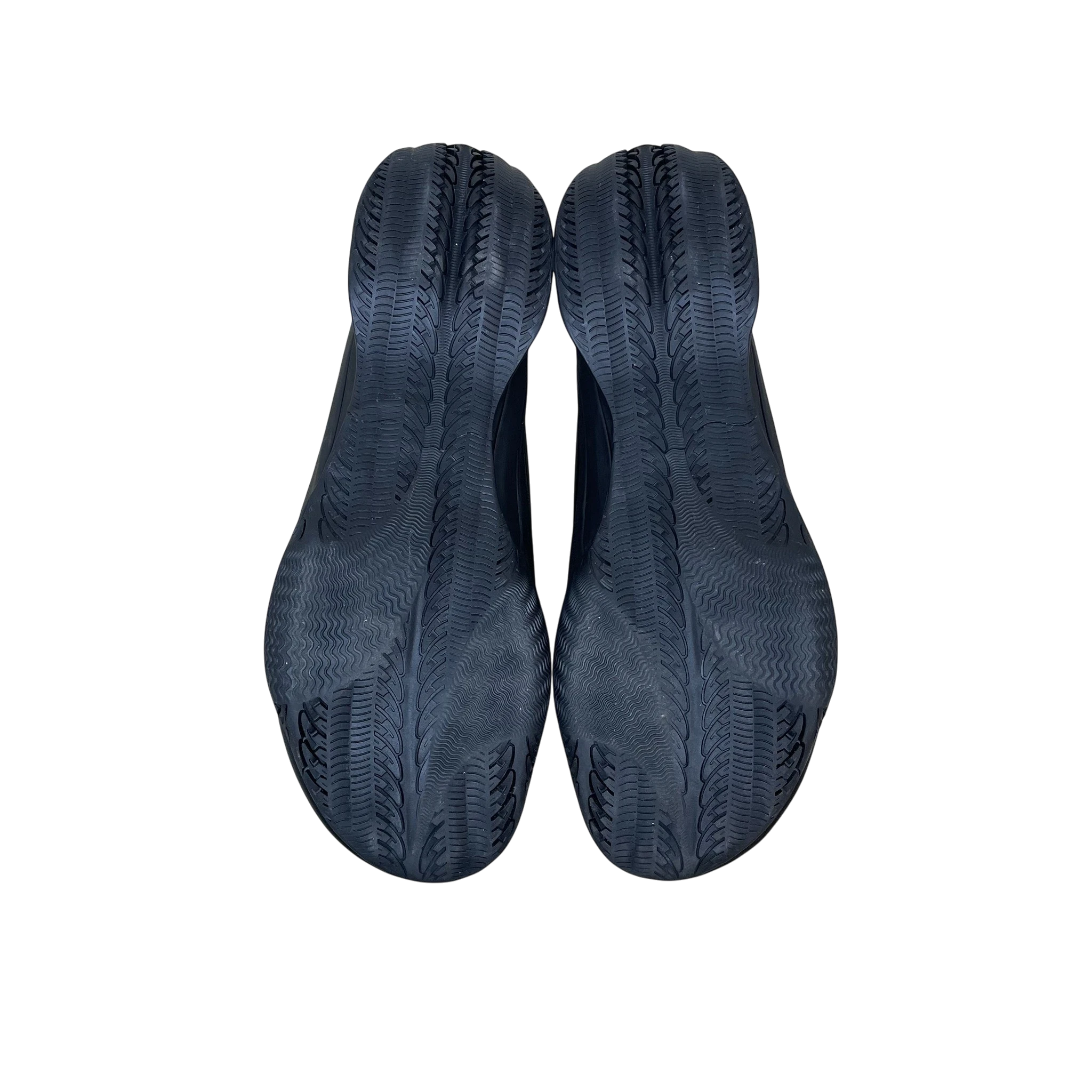 Zenno Archive Puma x Rombaut Levitation sneakers in black, showing the textured rubber outsoles from a bottom view.