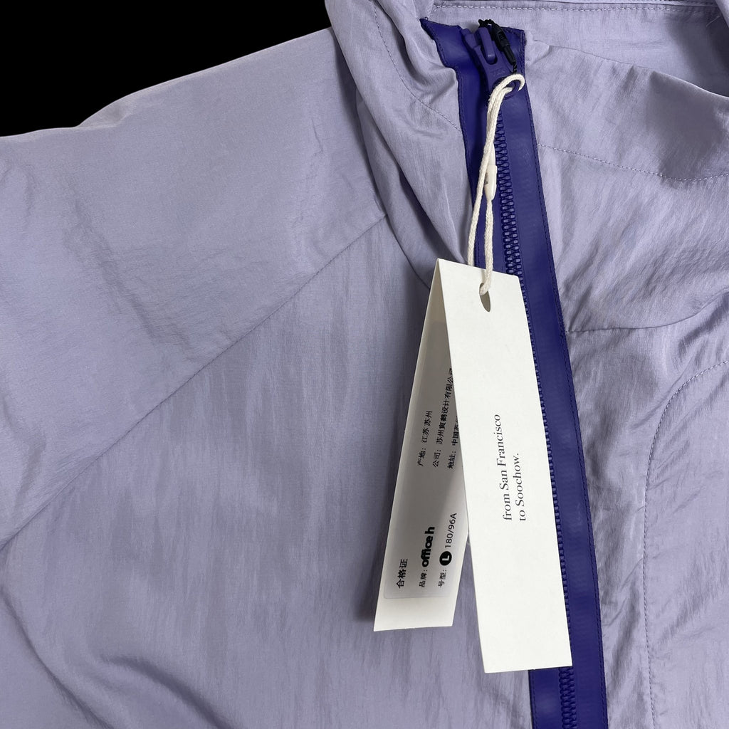 Zenno Archive Office H purple nylon hooded jacket with a contrasting dark blue zipper and attached product tags