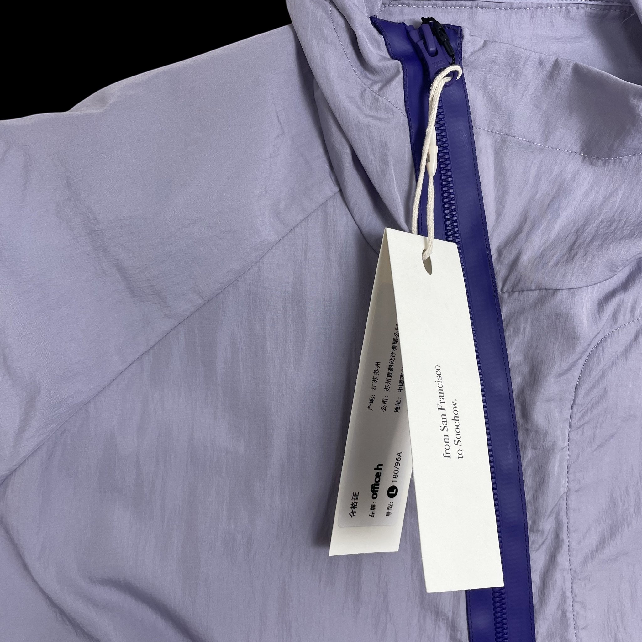 Zenno Archive Office H purple nylon hooded jacket with a contrasting dark blue zipper and attached product tags