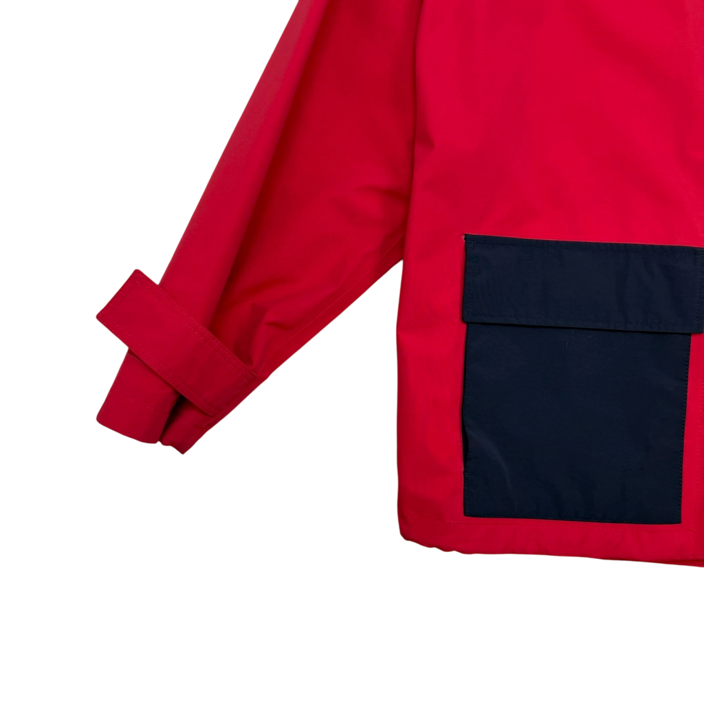 Zenno Archive J.W. Anderson oversized red jacket with a contrasting black pocket and adjustable sleeve strap detail.