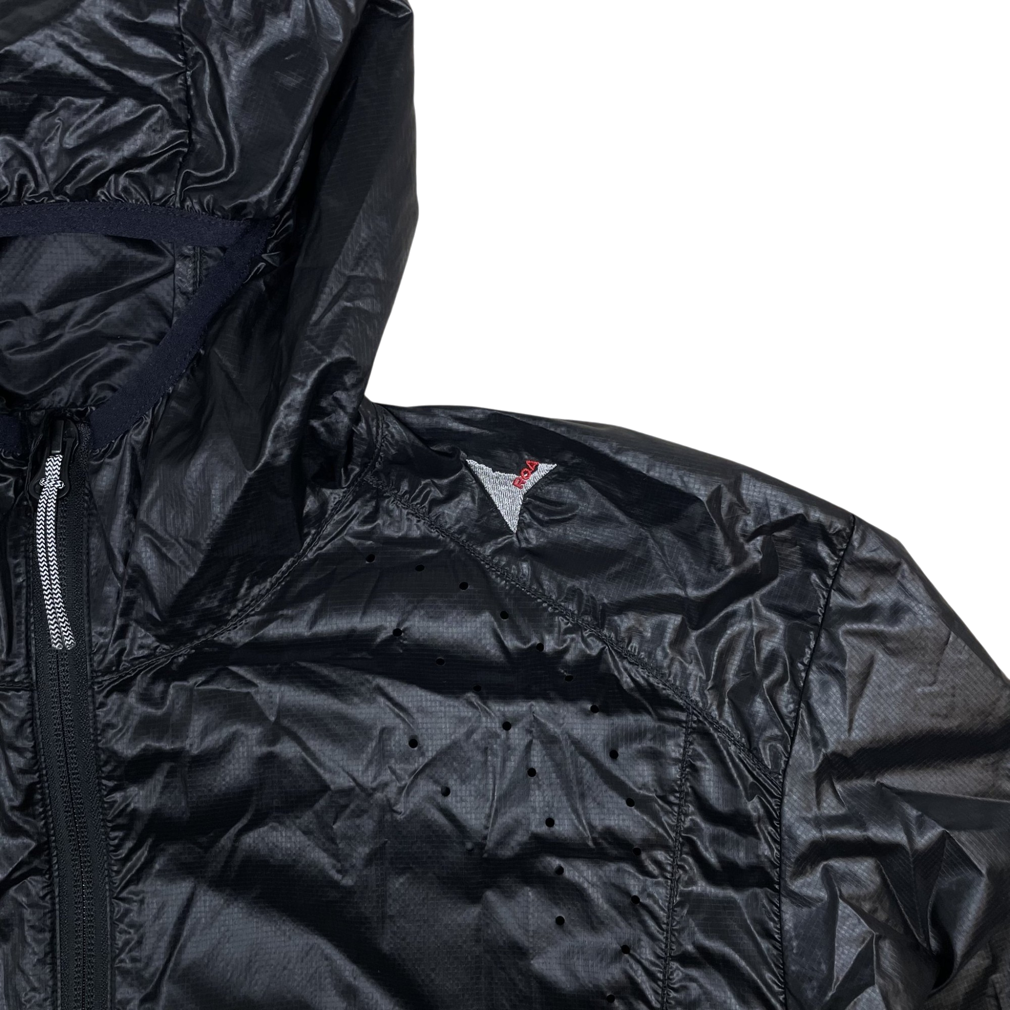 Zenno Archive ROA Hue packable black wind jacket with laser-cut ventilation holes and red logo detail