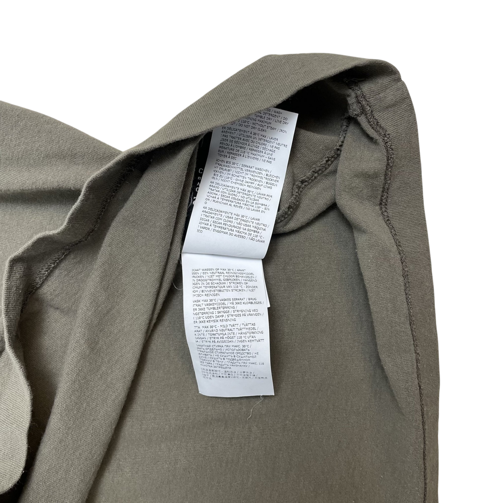 Zenno Archive Stone Island green t-shirt interior care label with multi-language washing instructions