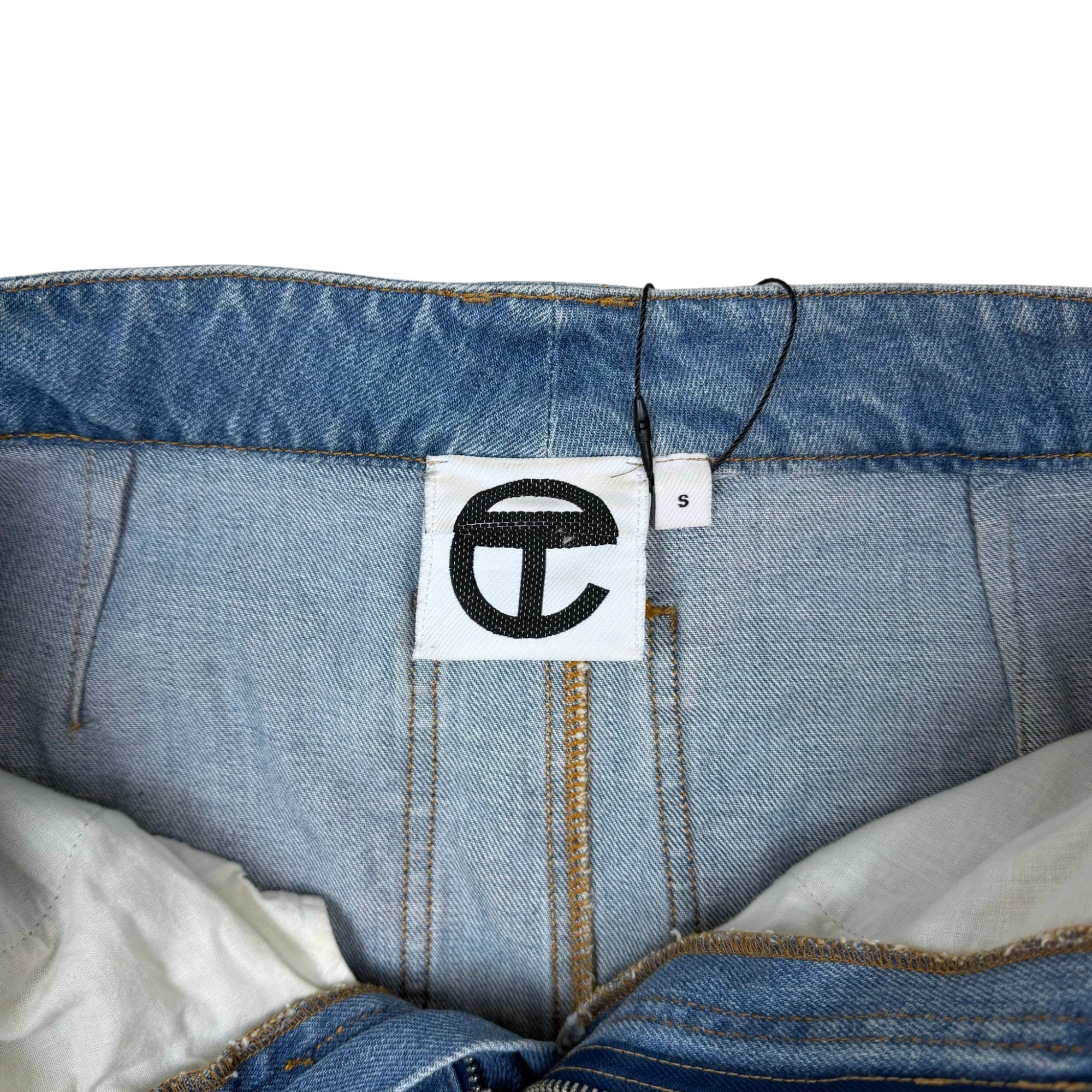 Zenno Archive Telfar denim cargo pants featuring a white interior brand label with the iconic black T logo and size S
